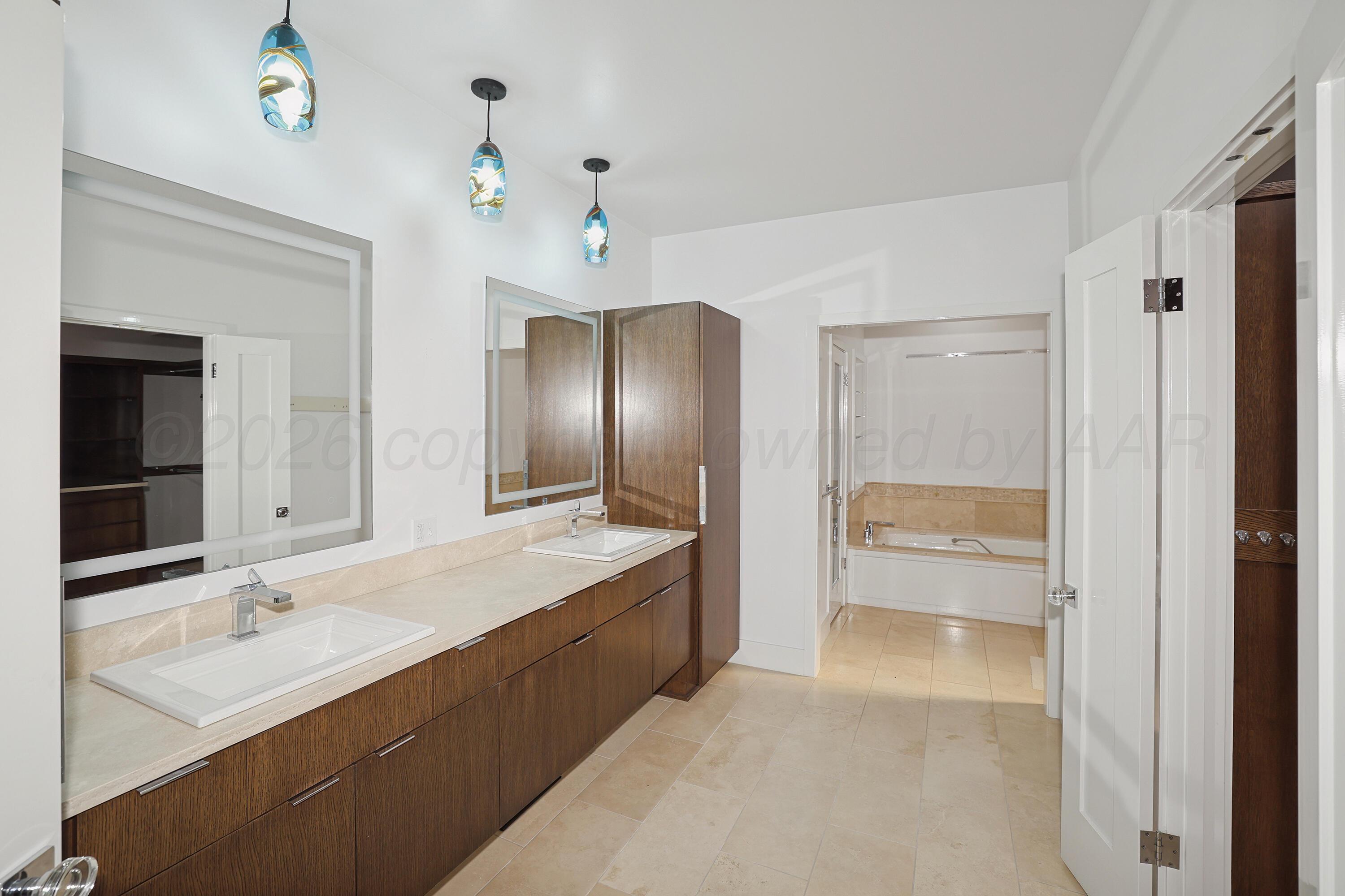 2 Woodstone Street Amarillo, TX 79106 - Photo 16 of 34 a bathroom with a tub sink and mirror