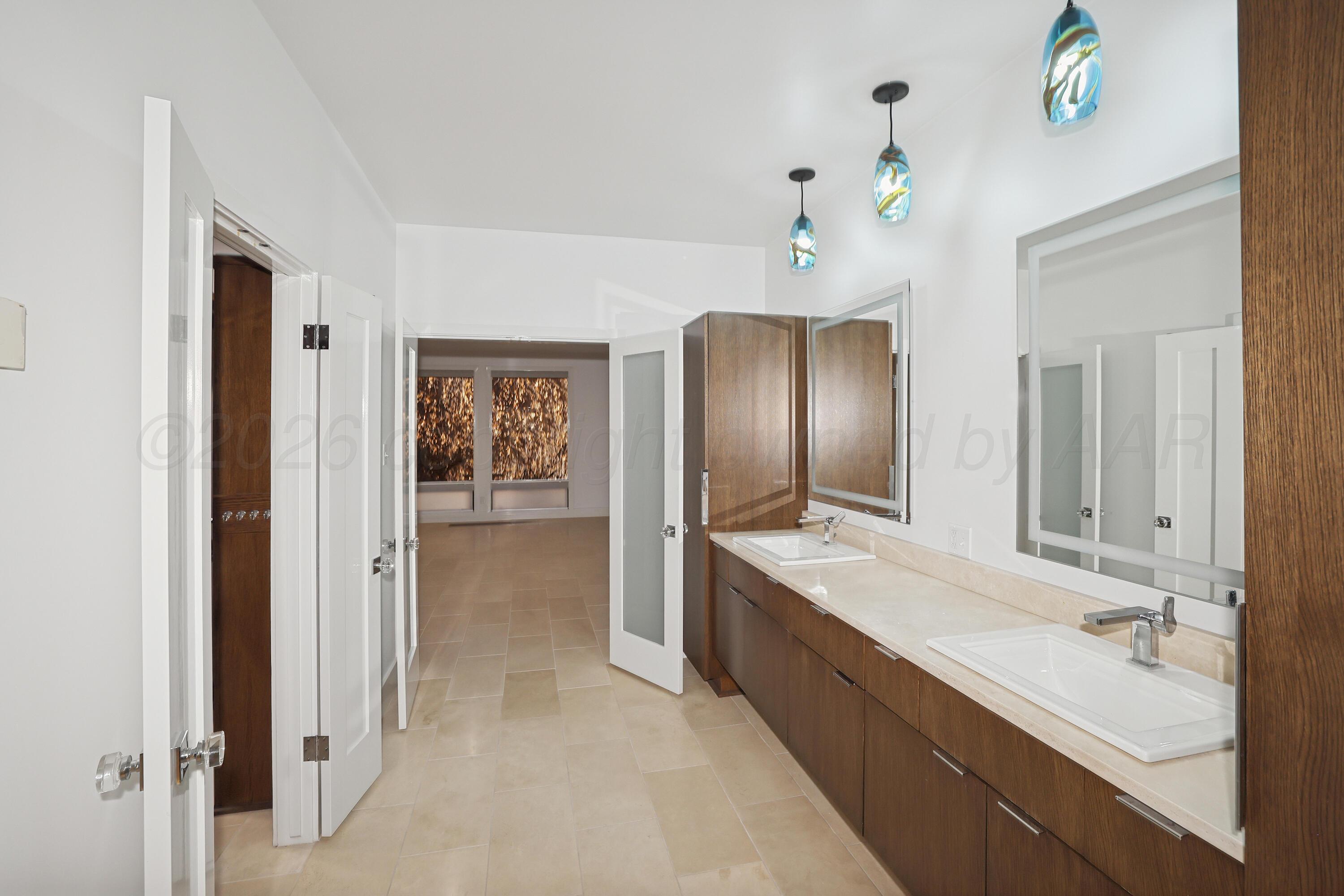 2 Woodstone Street Amarillo, TX 79106 - Photo 17 of 34 a spacious bathroom with a double vanity sink and a mirror