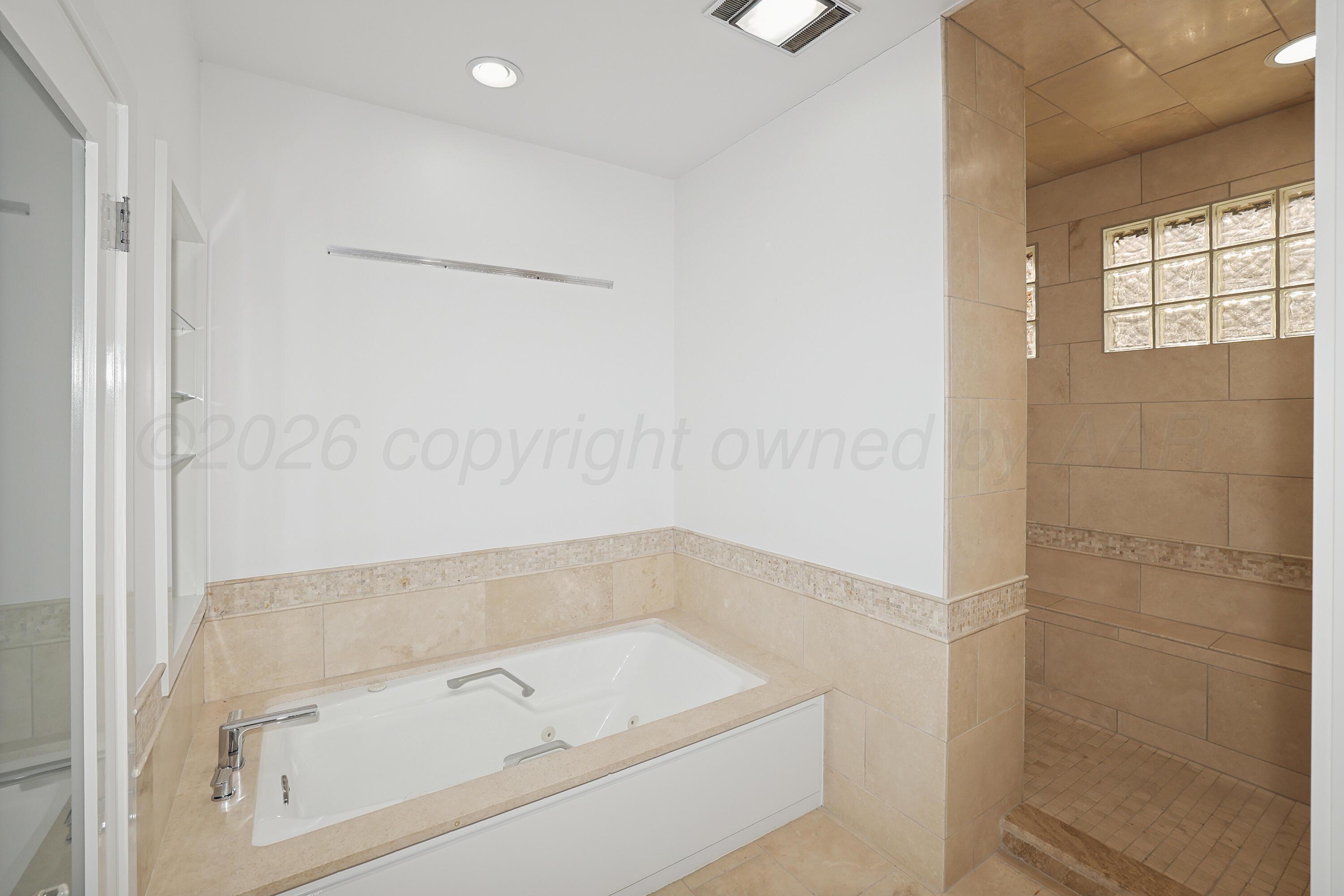 2 Woodstone Street Amarillo, TX 79106 - Photo 18 of 34 a bathroom with a tub and shower