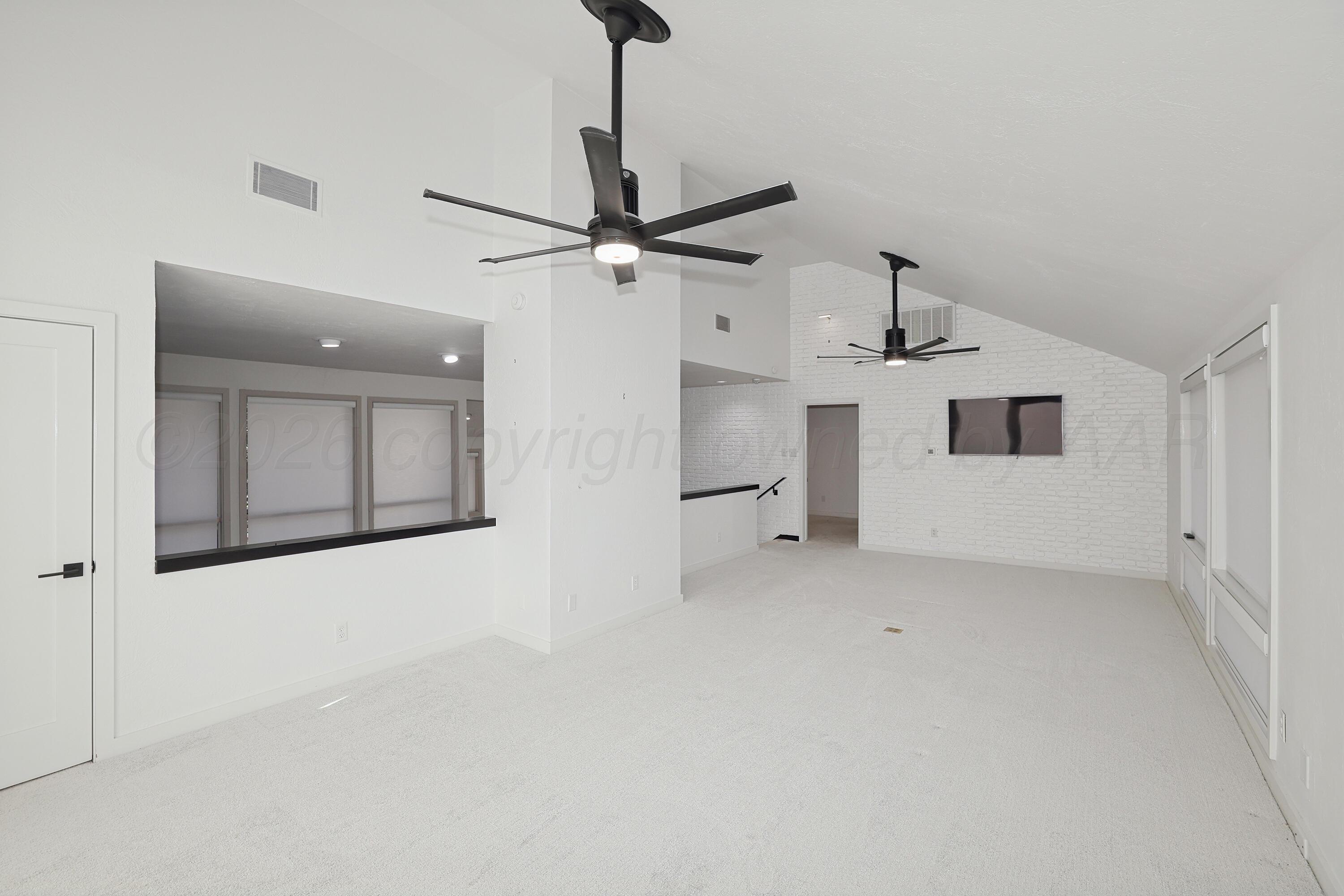 2 Woodstone Street Amarillo, TX 79106 - Photo 22 of 34 a view of a livingroom with a ceiling fan and window