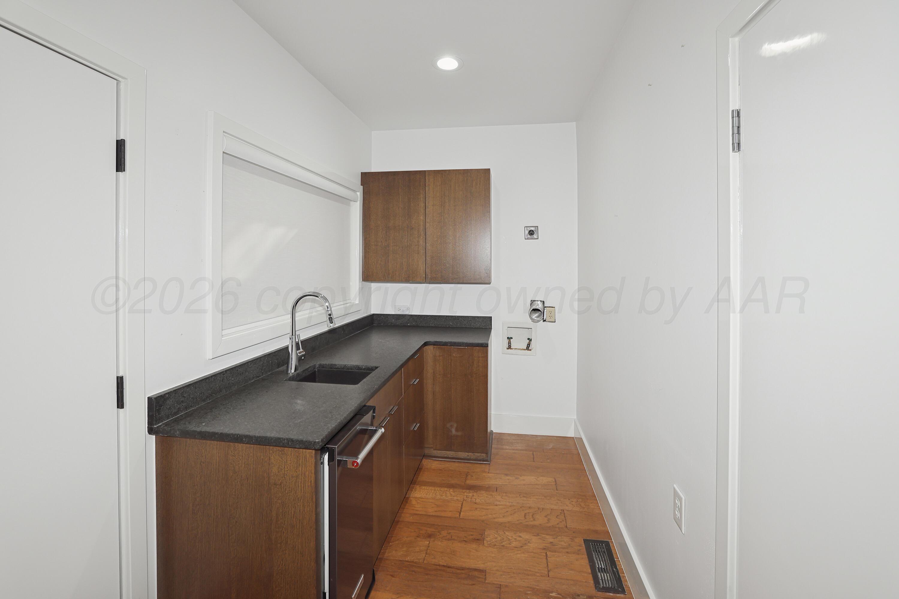 2 Woodstone Street Amarillo, TX 79106 - Photo 29 of 34 a utility room with cabinets washer and dryer