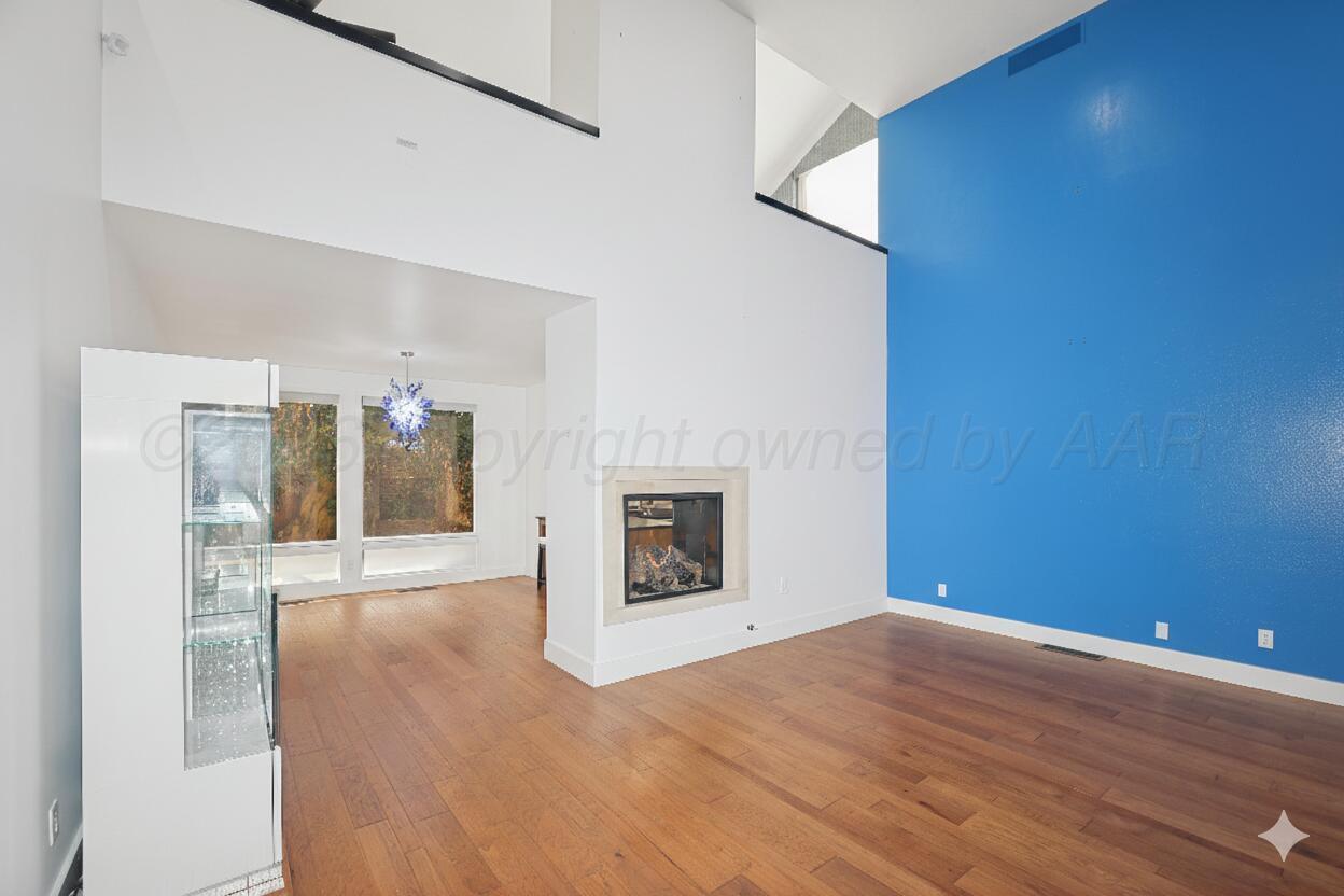 2 Woodstone Street Amarillo, TX 79106 - Photo 3 of 34 a view of an empty room with wooden floor and a fireplace
