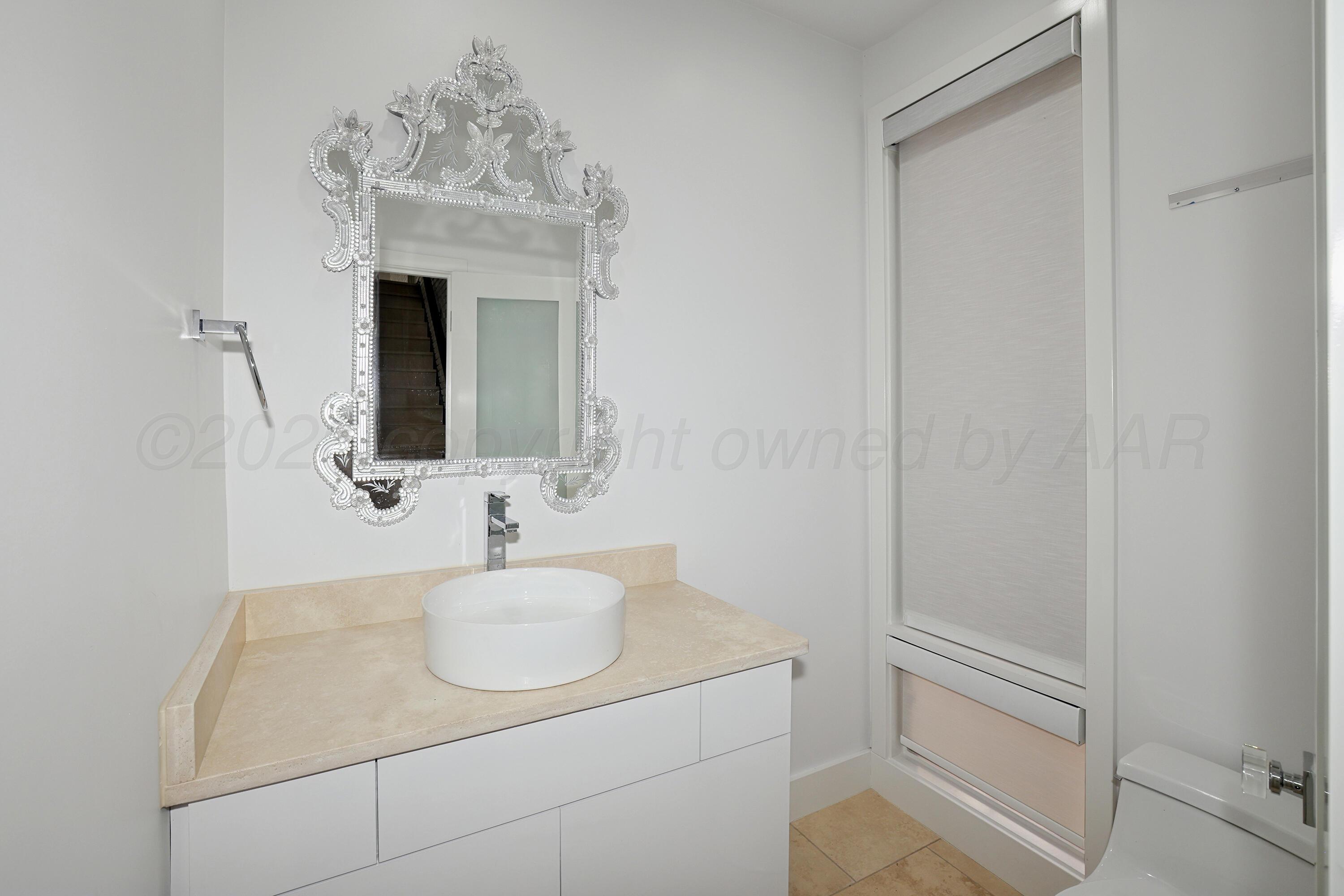 2 Woodstone Street Amarillo, TX 79106 - Photo 7 of 34 a bathroom with a sink and a mirror