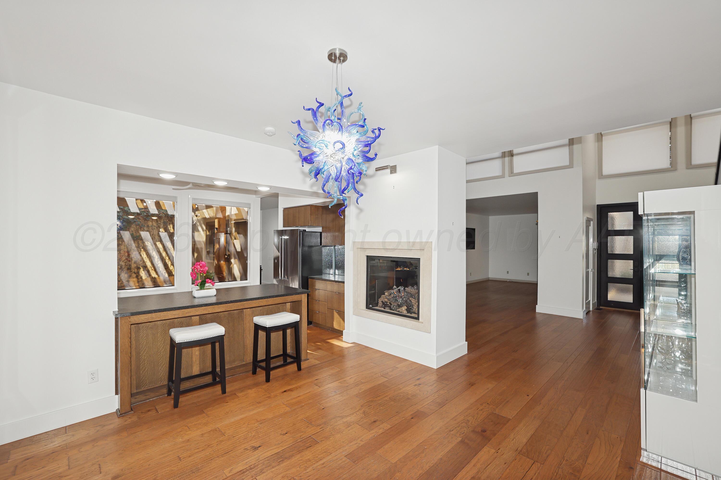 2 Woodstone Street Amarillo, TX 79106 - Photo 10 of 34 a living room with furniture a fireplace and a flat screen tv