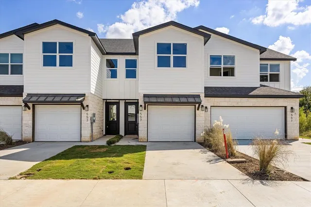 a living room with furniture kitchen and a table