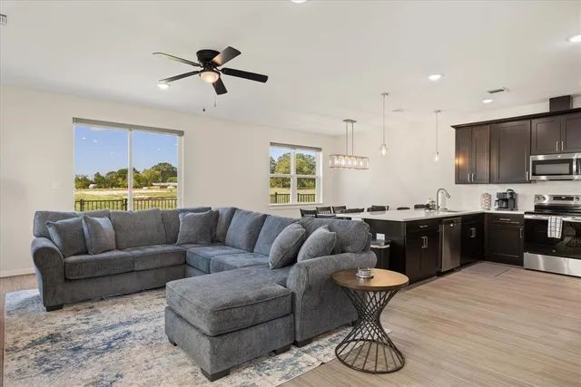 a living room with furniture and kitchen view