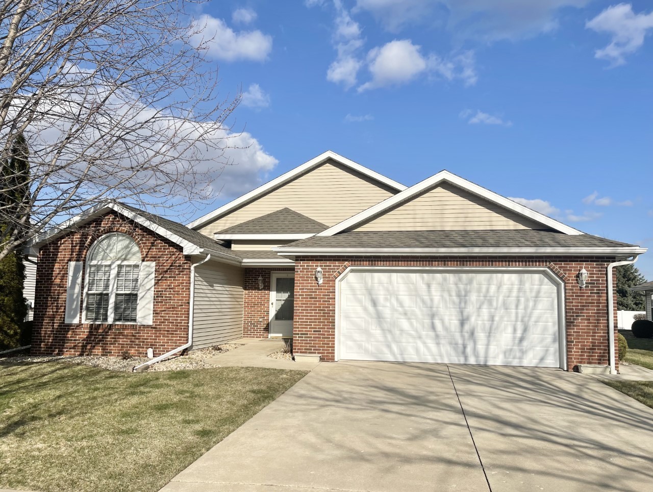 a view of a house with a yard and garage