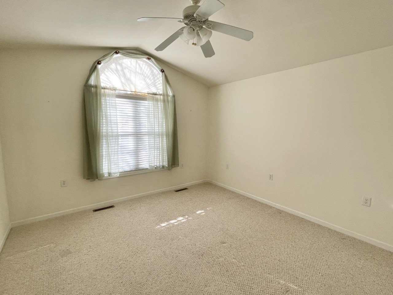 3219 Becker Drive Peru, IL 61354 - Photo 11 of 17 an empty room with a chandelier fan and windows