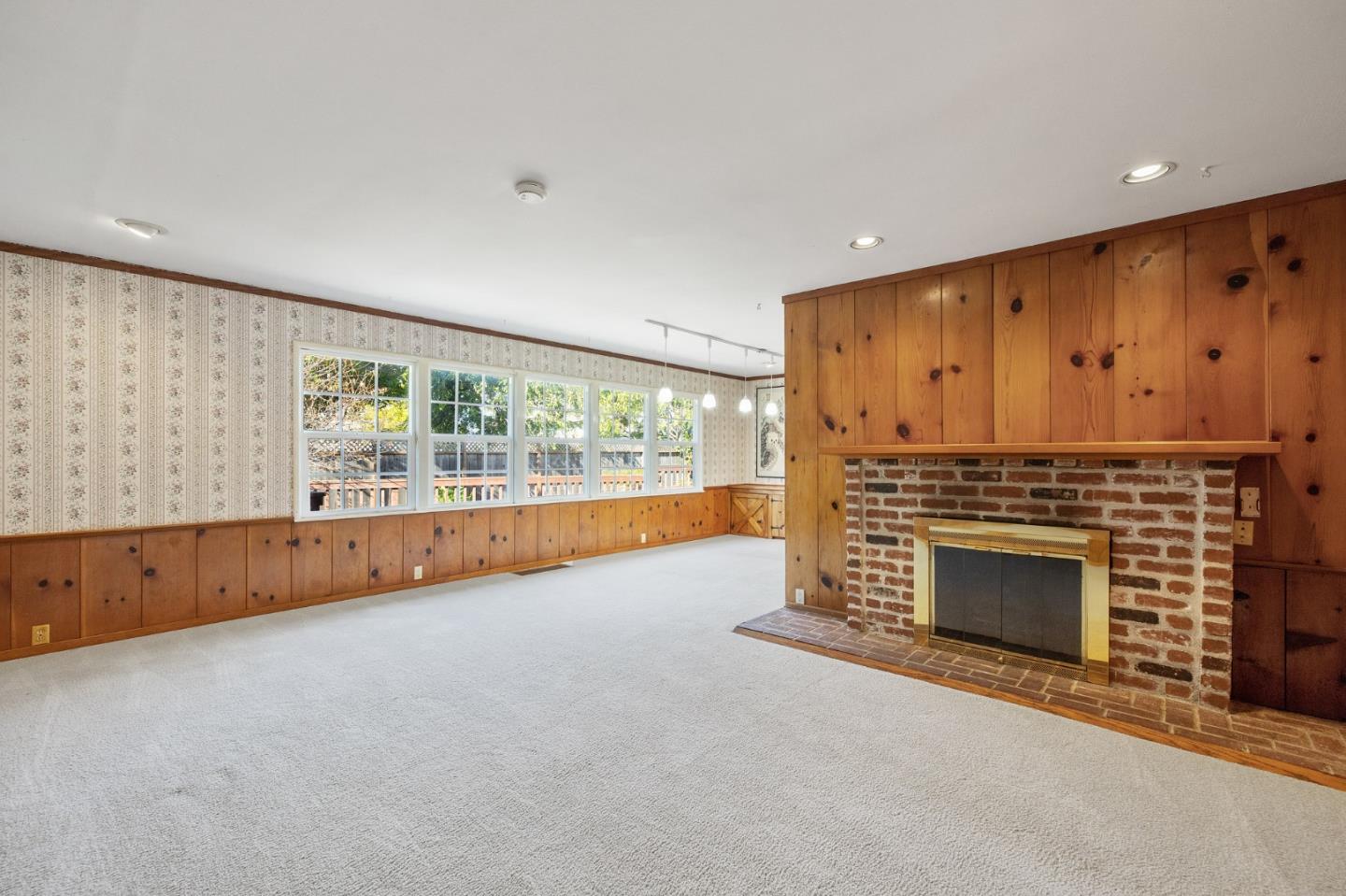 708 Johnston Street Half Moon Bay, CA 94019 - Photo 29 of 41 a view of an empty room with a fireplace and a window