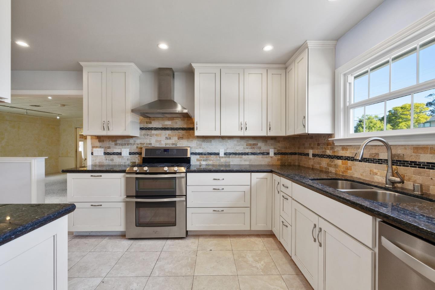 708 Johnston Street Half Moon Bay, CA 94019 - Photo 35 of 41 a kitchen with granite countertop white cabinets and appliances