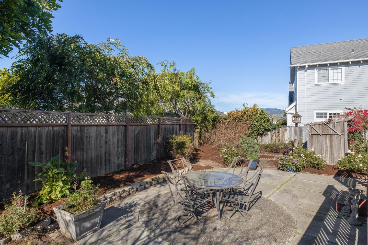 708 Johnston Street Half Moon Bay, CA 94019 - Photo 39 of 41 a view of a backyard with furniture and a garden