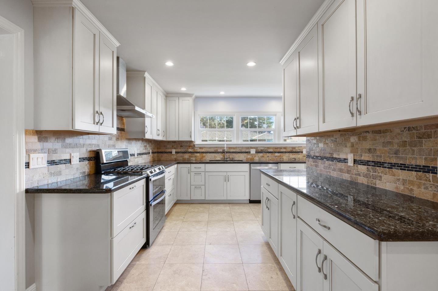 708 Johnston Street Half Moon Bay, CA 94019 - Photo 9 of 41 a large kitchen with stainless steel appliances granite countertop a stove sink and cabinets