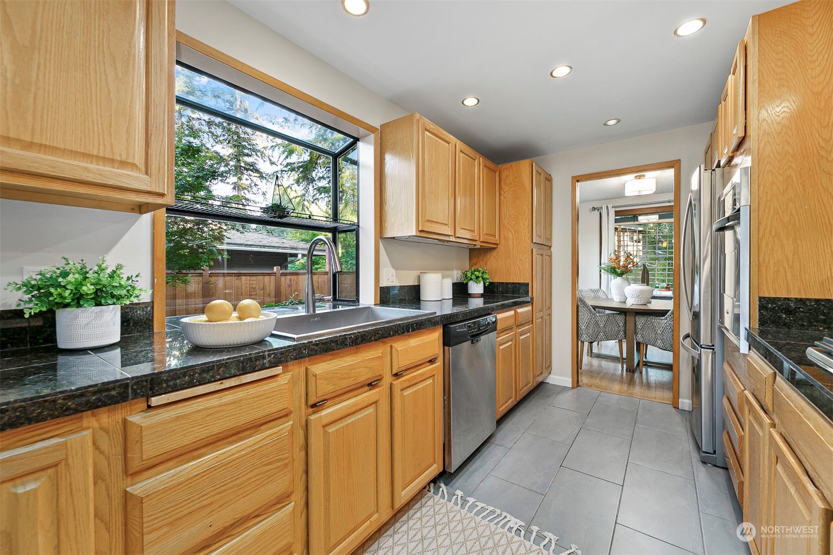 16611 Southeast 147th Street Renton, WA 98059 - Photo 8 of 32 a large kitchen with stainless steel appliances granite countertop a large window and a counter space