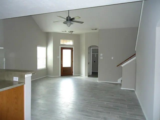 wooden floor in an empty room with a window