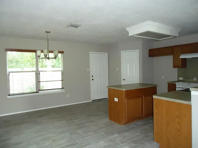 a kitchen with stainless steel appliances granite countertop a sink and a stove