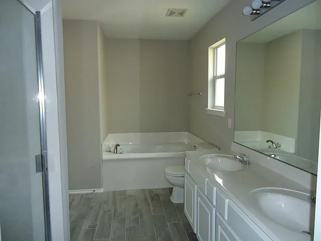 a bathroom with a sink a toilet and tub