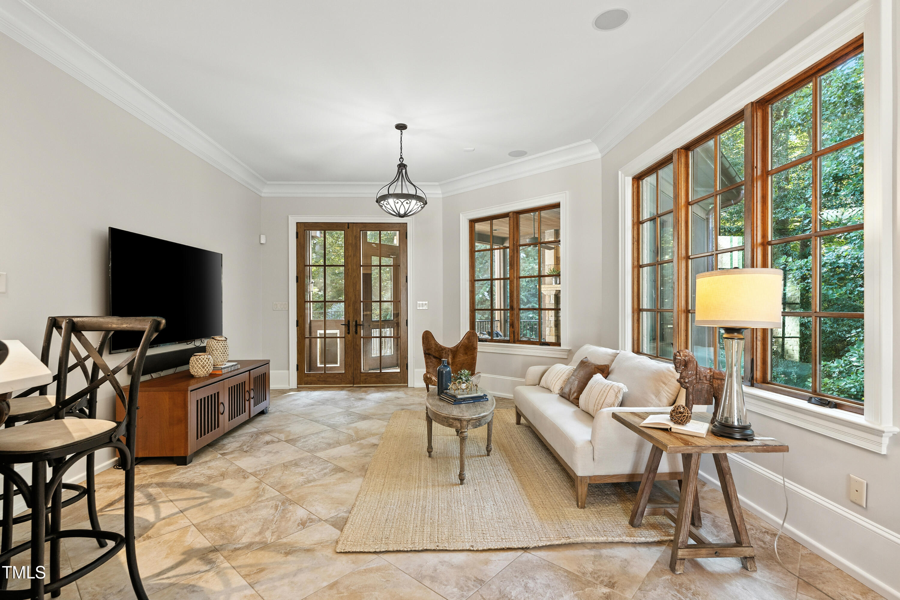11213 Jonas Ridge Lane Raleigh, NC 27613 - Photo 22 of 91 a living room with furniture a flat screen tv and large windows