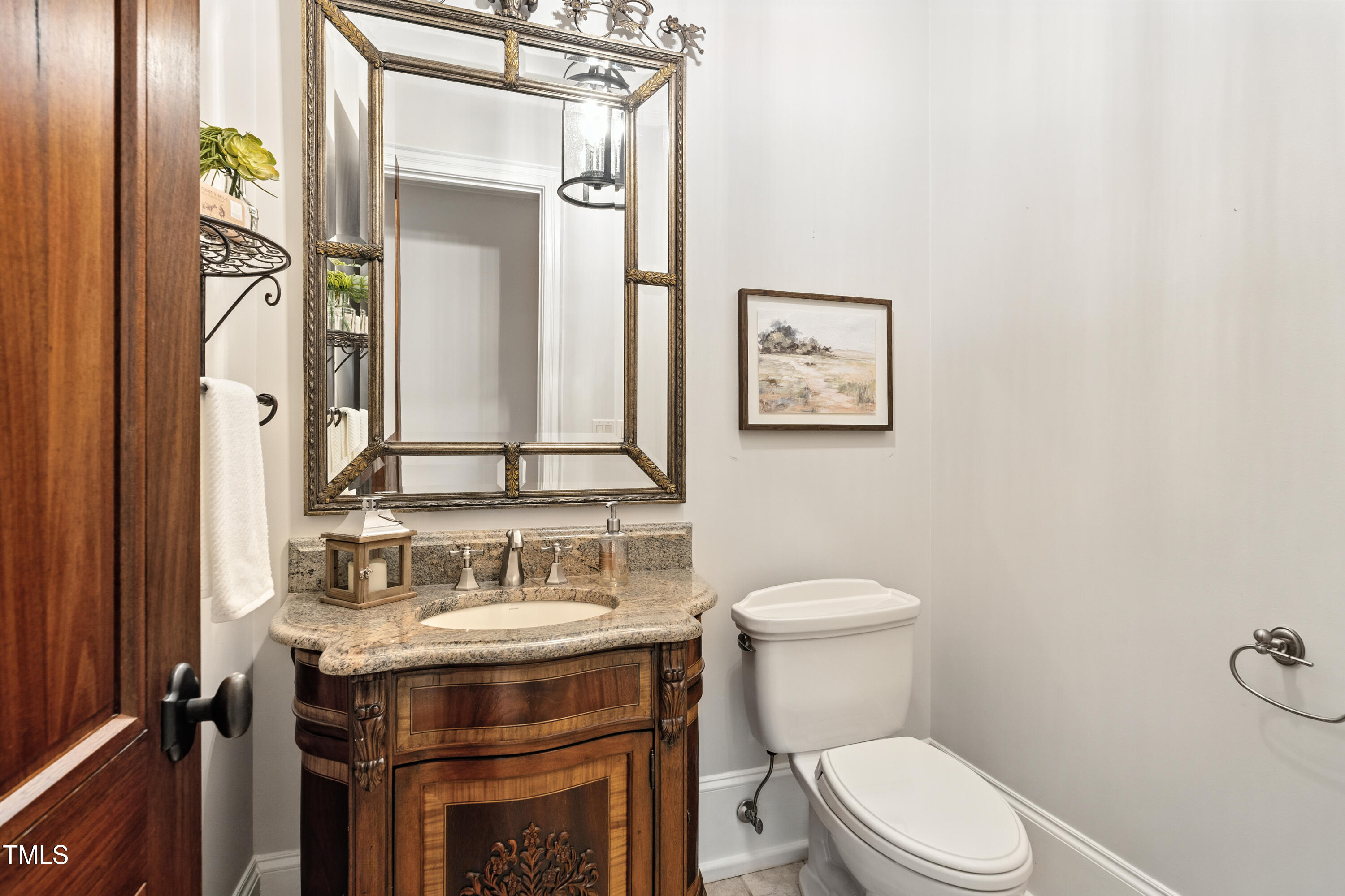 11213 Jonas Ridge Lane Raleigh, NC 27613 - Photo 29 of 91 a bathroom with a toilet a sink and a mirror