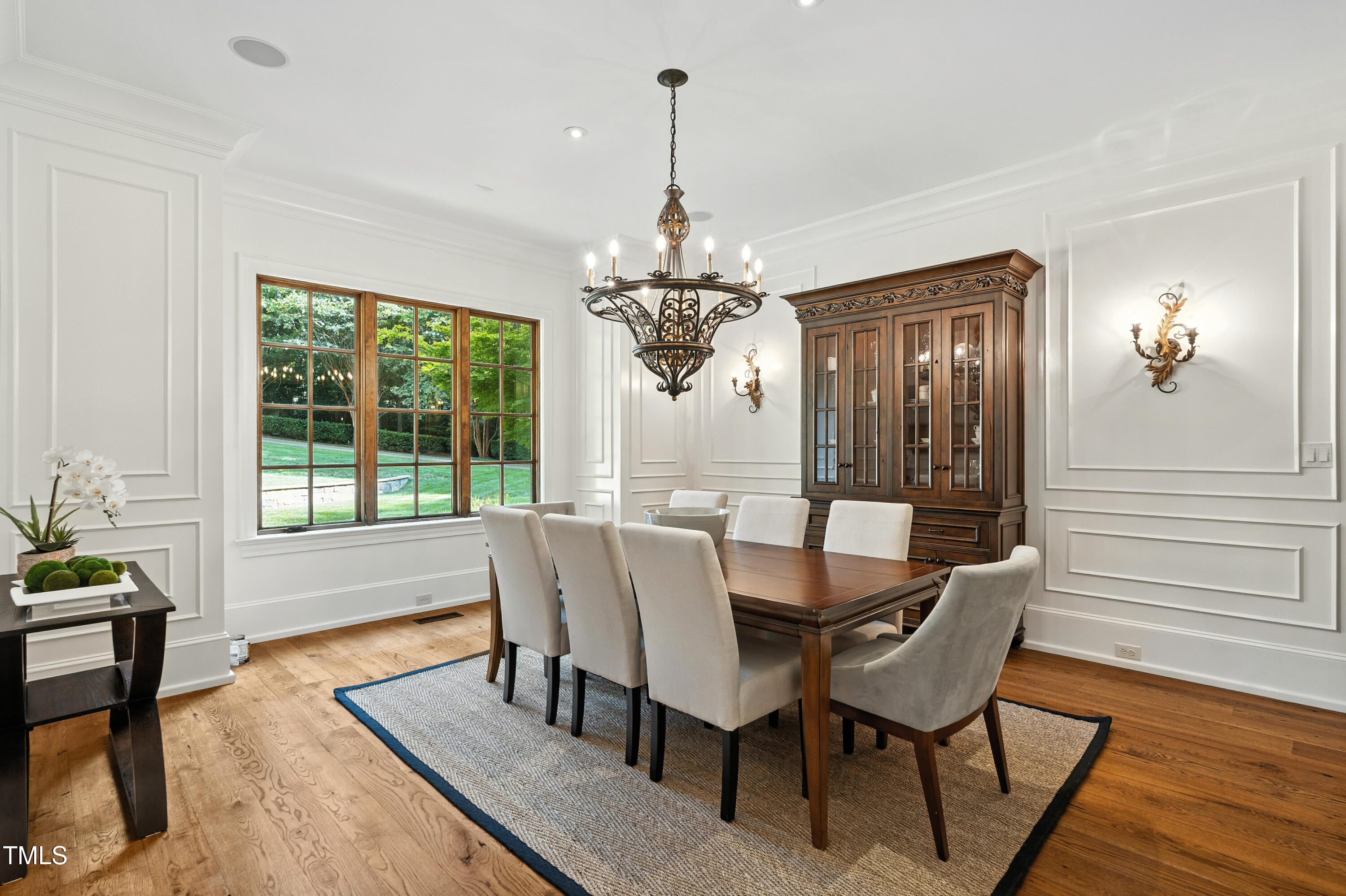 11213 Jonas Ridge Lane Raleigh, NC 27613 - Photo 32 of 91 a dining room with furniture a chandelier and wooden floor