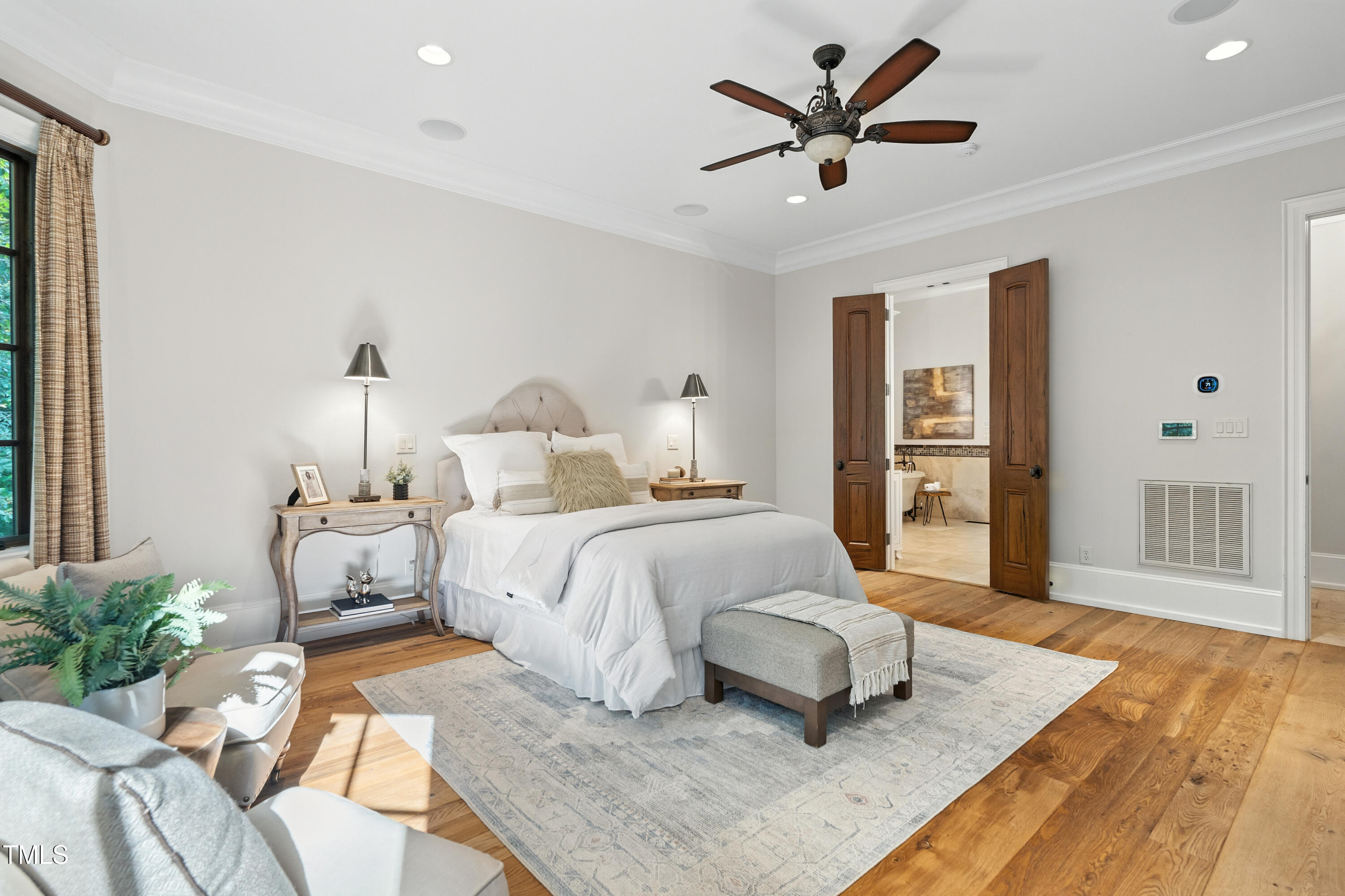 11213 Jonas Ridge Lane Raleigh, NC 27613 - Photo 35 of 91 a bedroom with a bed and a chandelier