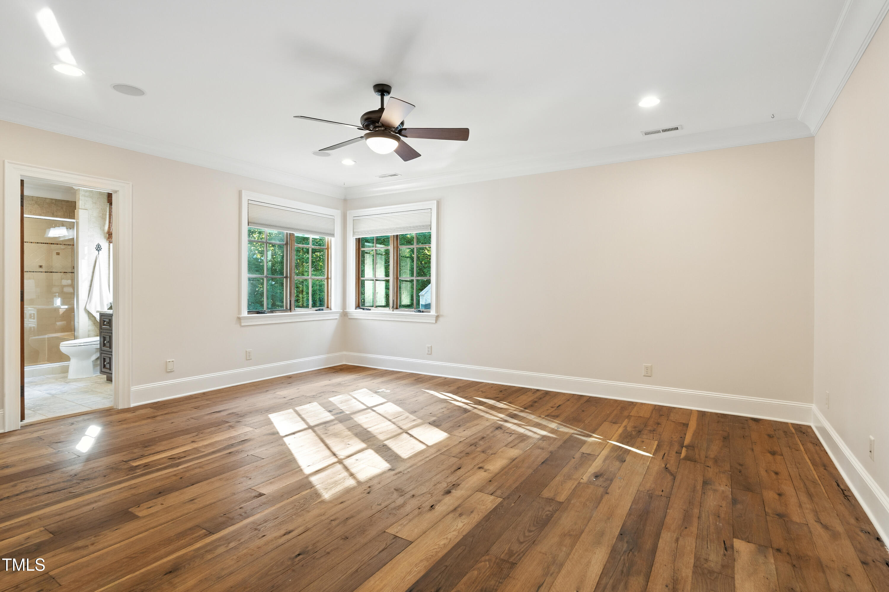 11213 Jonas Ridge Lane Raleigh, NC 27613 - Photo 47 of 91 a view of empty room with wooden floor and fan