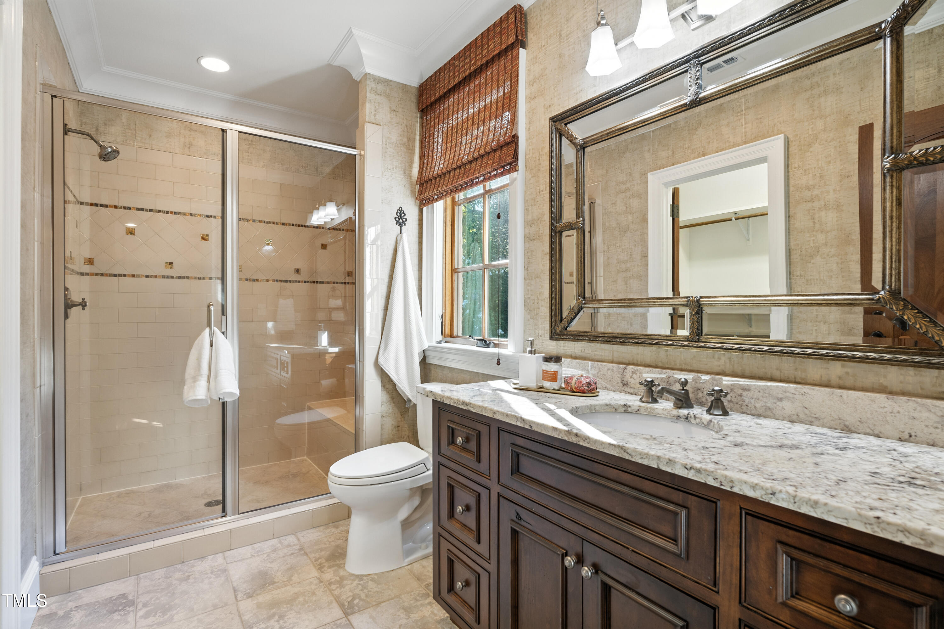 11213 Jonas Ridge Lane Raleigh, NC 27613 - Photo 48 of 91 a bathroom with a granite countertop sink a toilet a mirror and shower