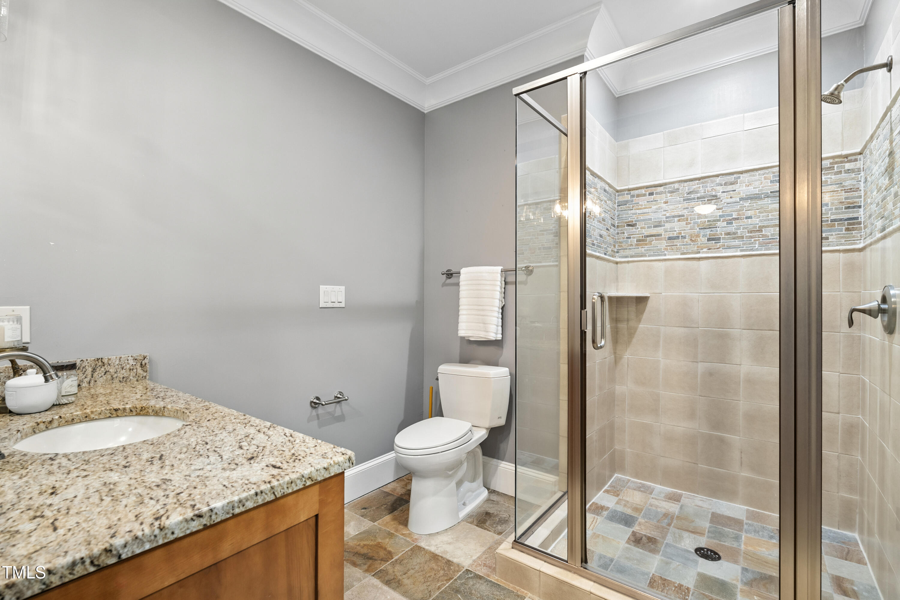 11213 Jonas Ridge Lane Raleigh, NC 27613 - Photo 50 of 91 a bathroom with a granite countertop sink a toilet and shower