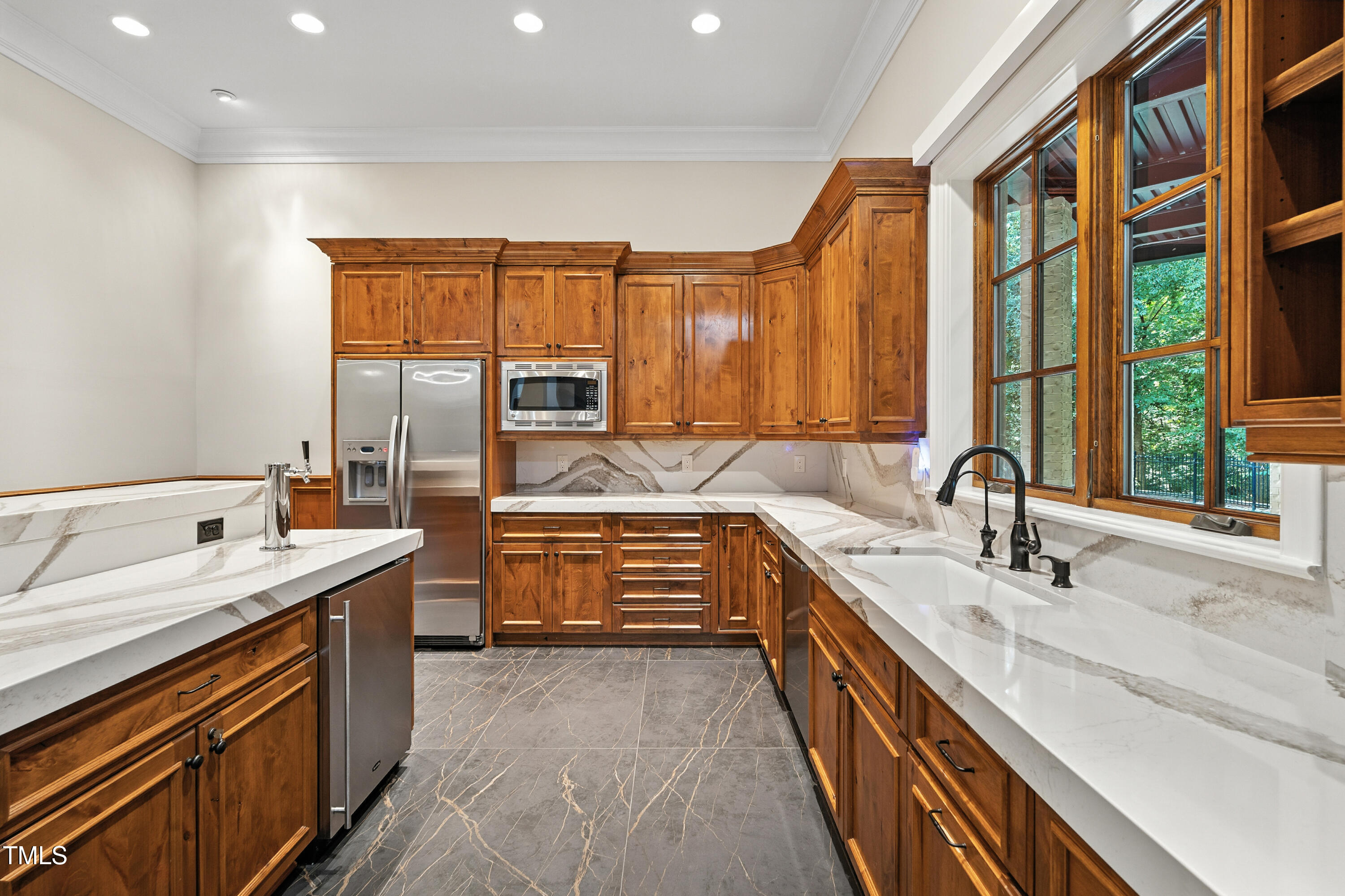 11213 Jonas Ridge Lane Raleigh, NC 27613 - Photo 61 of 91 a kitchen with stainless steel appliances a sink stove and cabinets