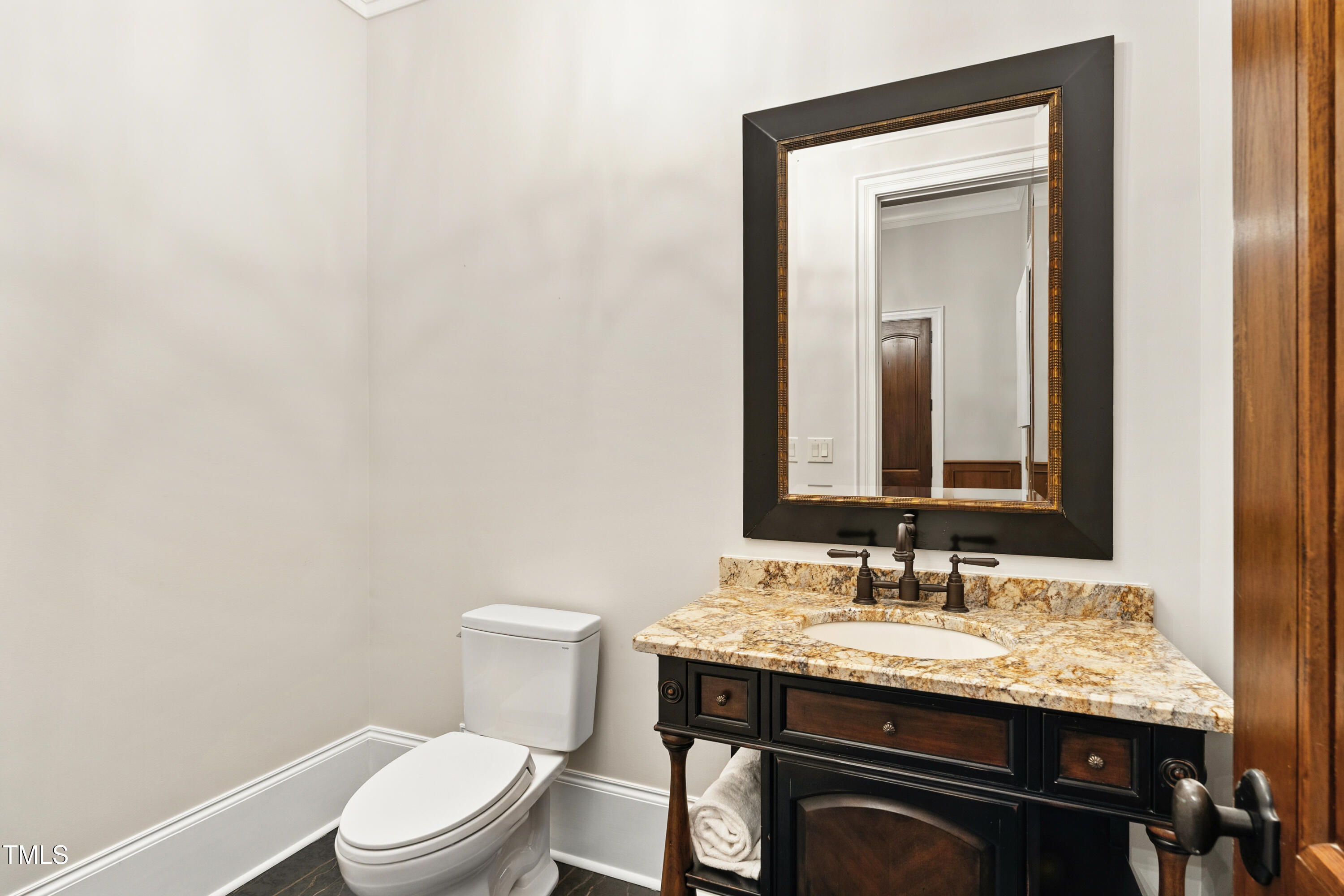11213 Jonas Ridge Lane Raleigh, NC 27613 - Photo 64 of 91 a bathroom with a granite countertop toilet sink and mirror