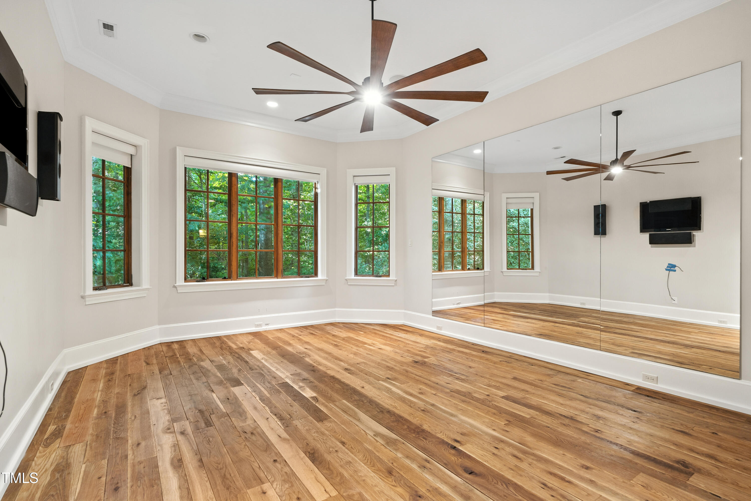 11213 Jonas Ridge Lane Raleigh, NC 27613 - Photo 65 of 91 a view of an empty room with wooden floor and a window