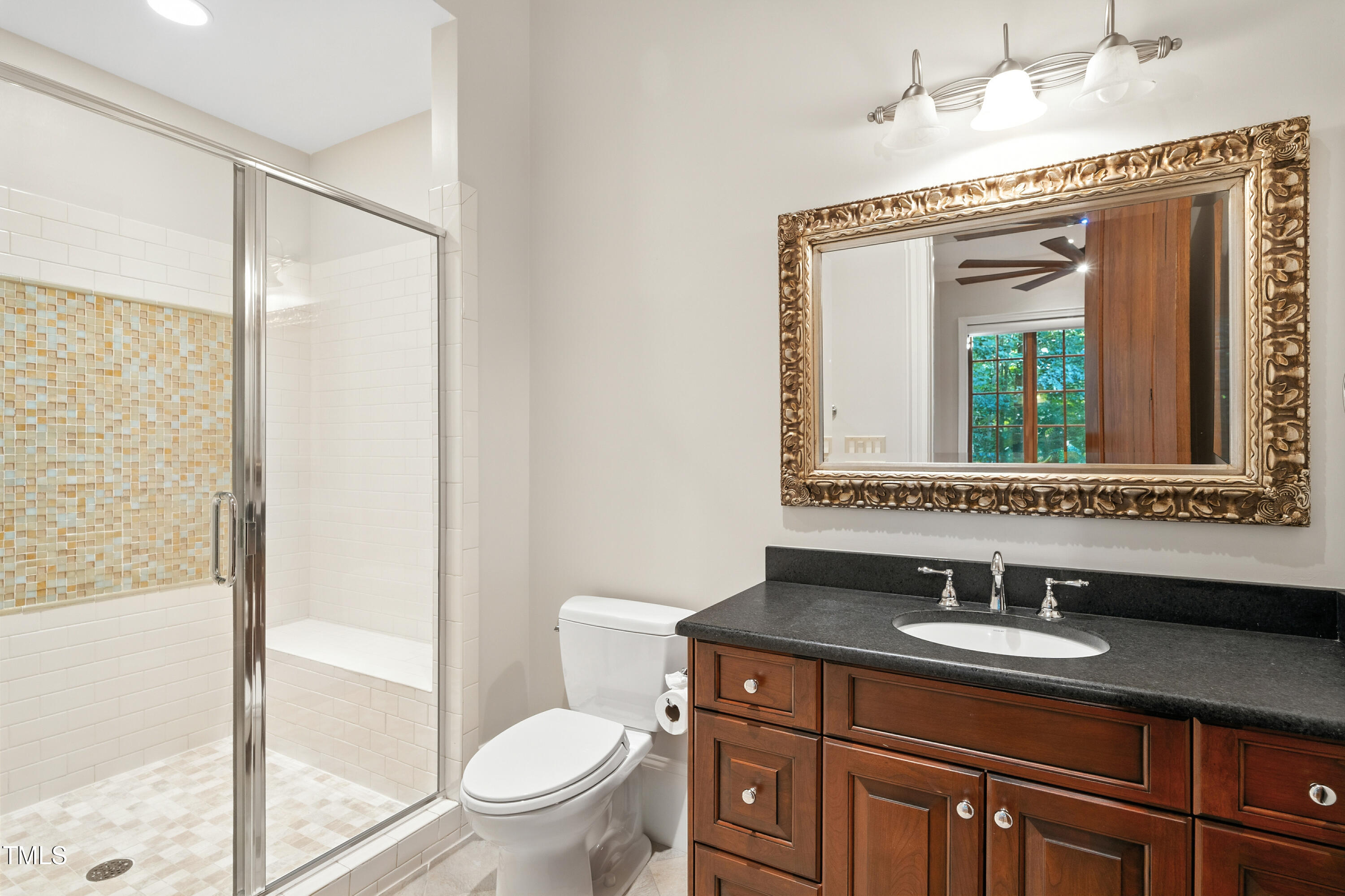 11213 Jonas Ridge Lane Raleigh, NC 27613 - Photo 67 of 91 a bathroom with a sink a toilet a mirror and shower