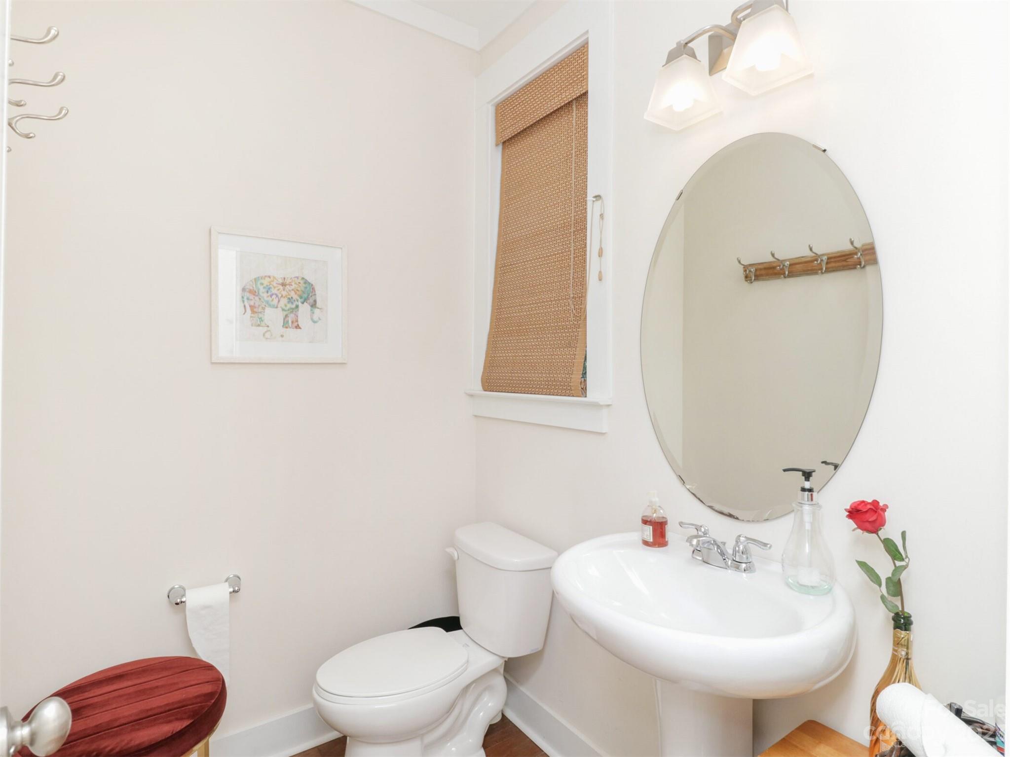 2634 Double Oaks Road Charlotte, NC 28206 - Photo 11 of 48 a bathroom with a toilet sink and mirror