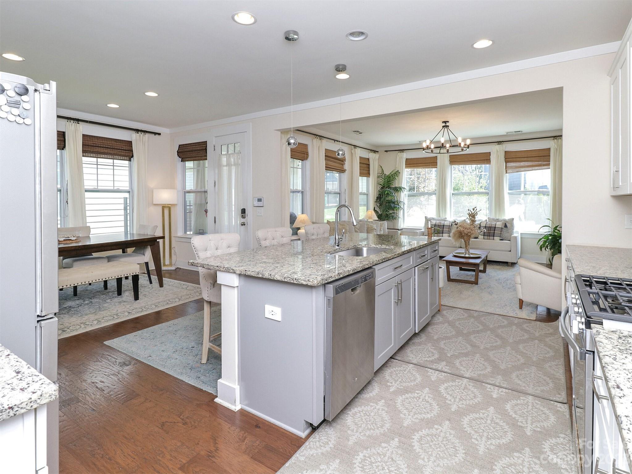 2634 Double Oaks Road Charlotte, NC 28206 - Photo 12 of 48 a large kitchen with kitchen island a large counter top space a sink stainless steel appliances and windows
