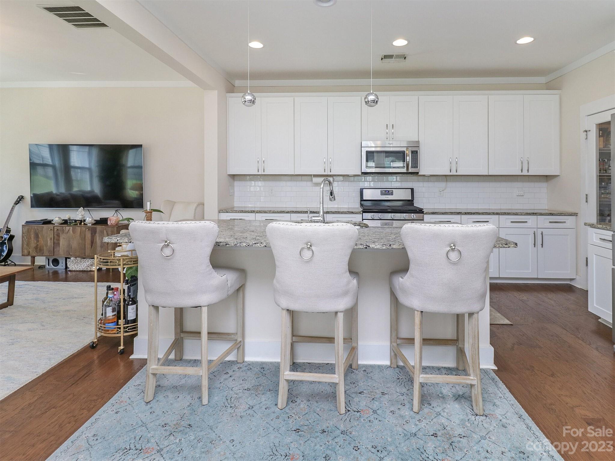 2634 Double Oaks Road Charlotte, NC 28206 - Photo 15 of 48 a kitchen with a dining table chairs and microwave