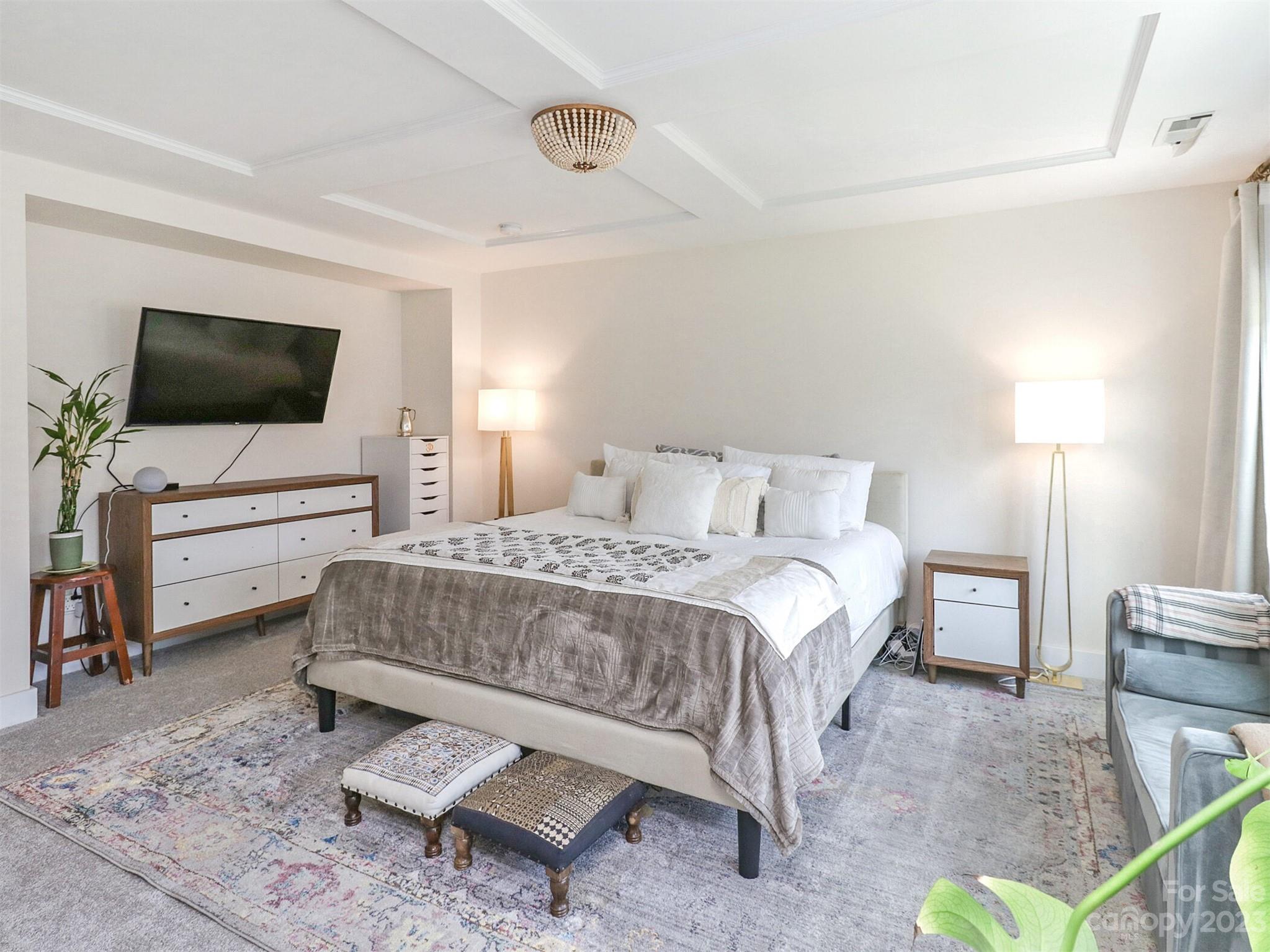 2634 Double Oaks Road Charlotte, NC 28206 - Photo 26 of 48 a bedroom with a bed and a flat screen tv