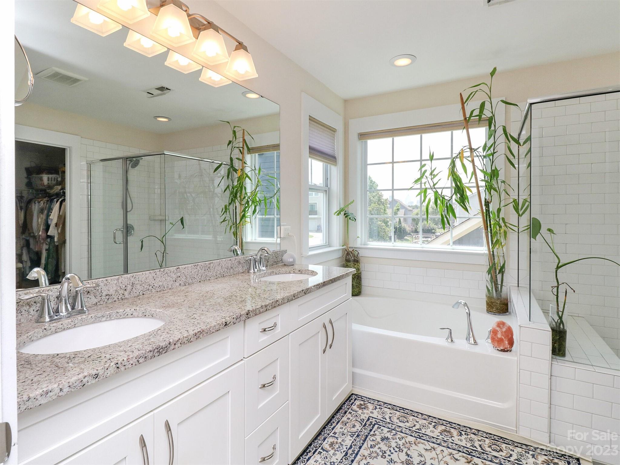 2634 Double Oaks Road Charlotte, NC 28206 - Photo 27 of 48 a bathroom with a granite countertop sink mirror and a bathtub