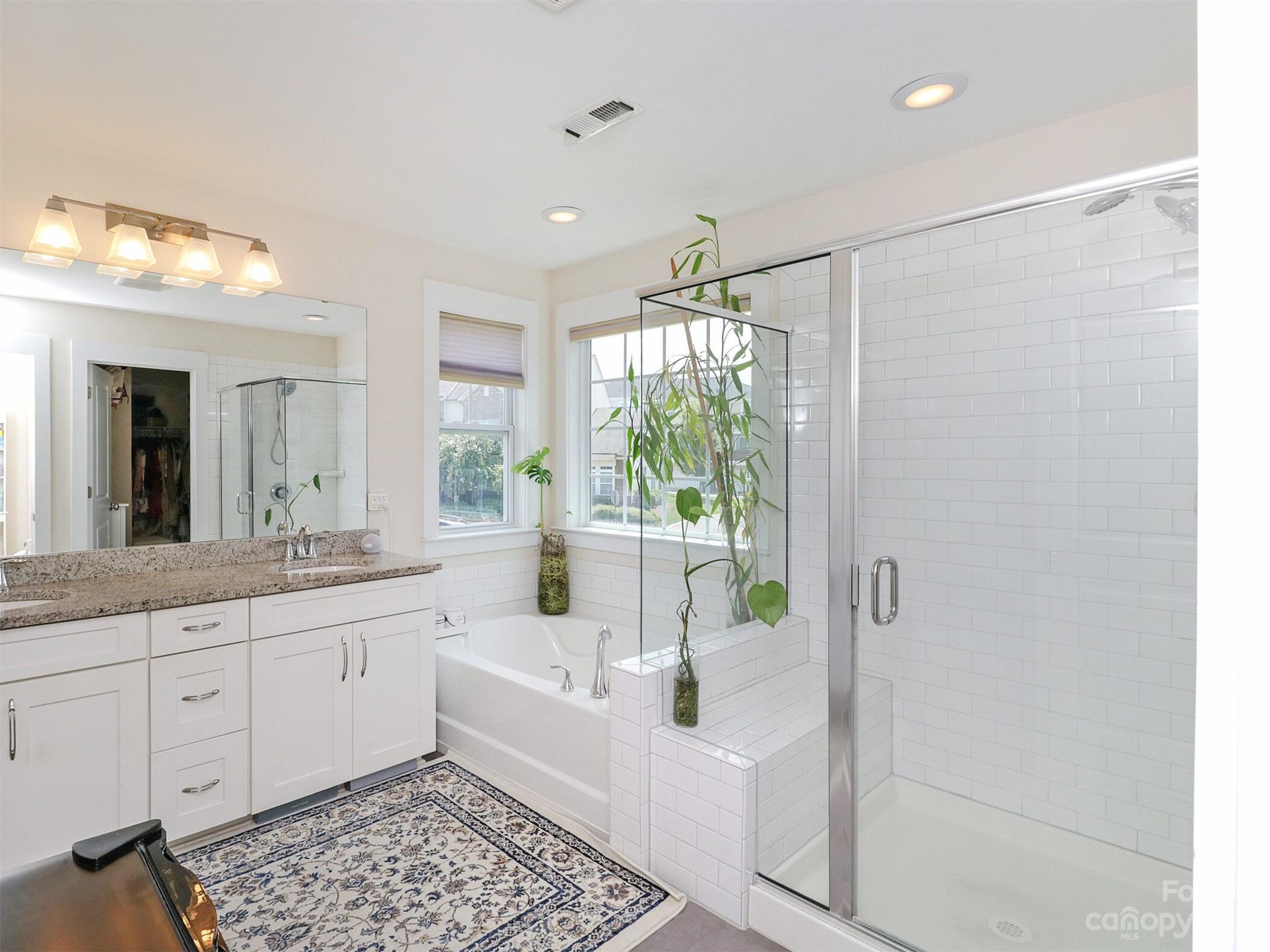 2634 Double Oaks Road Charlotte, NC 28206 - Photo 29 of 48 a large white bathroom with a granite countertop sink a mirror and a shower