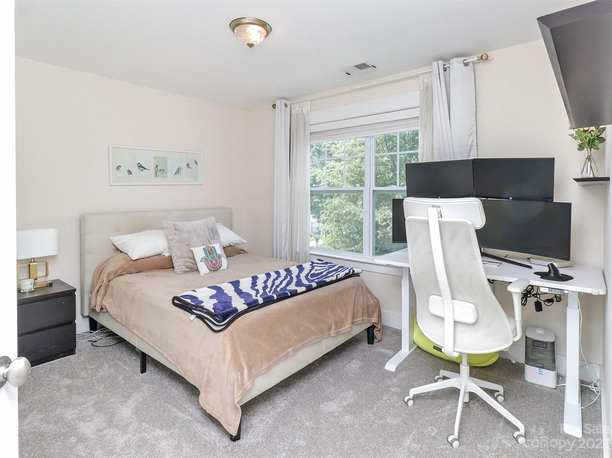 2634 Double Oaks Road Charlotte, NC 28206 - Photo 30 of 48 a bed room with a bed and a chair