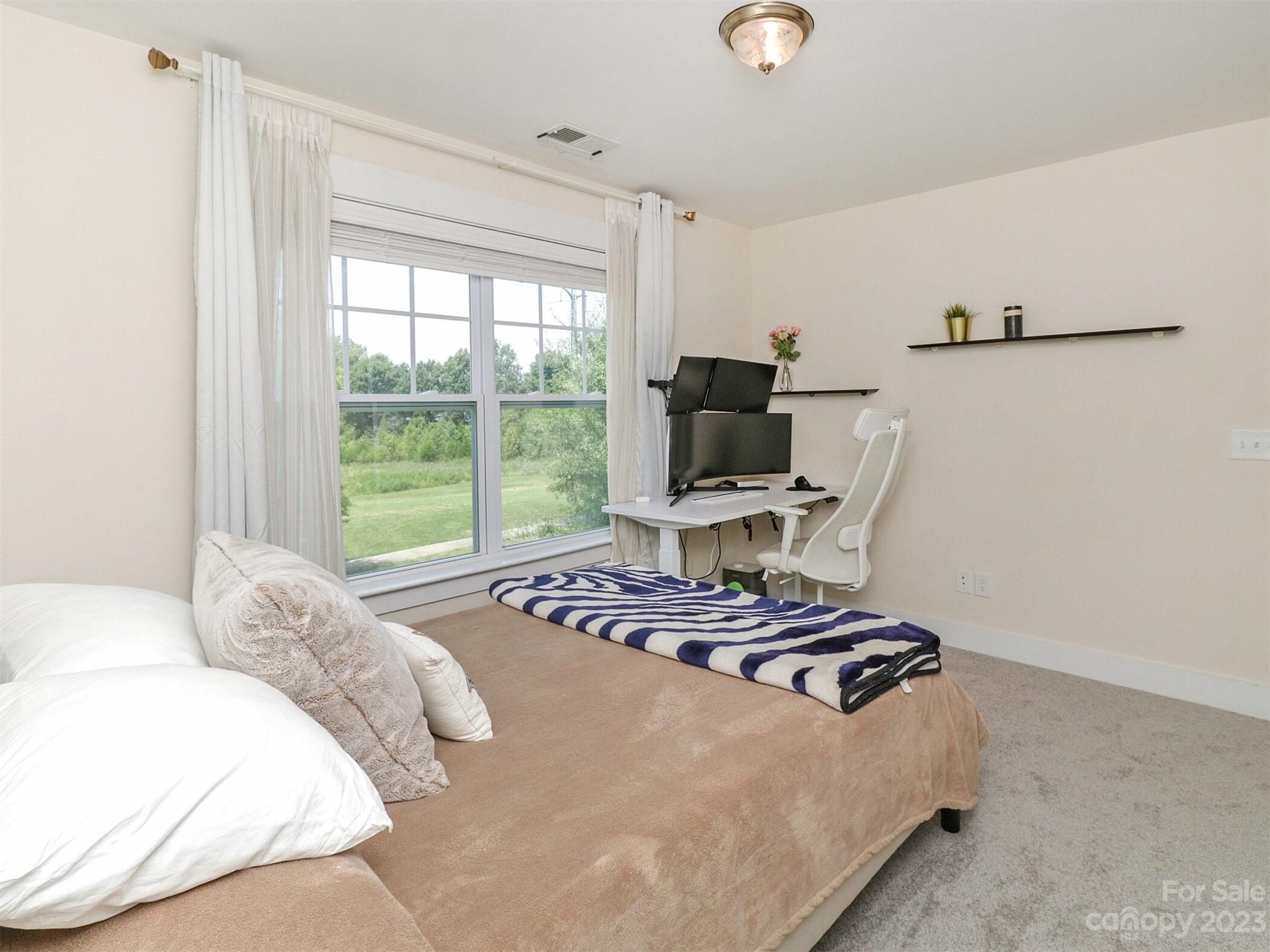 2634 Double Oaks Road Charlotte, NC 28206 - Photo 31 of 48 a bedroom with a bed and a window