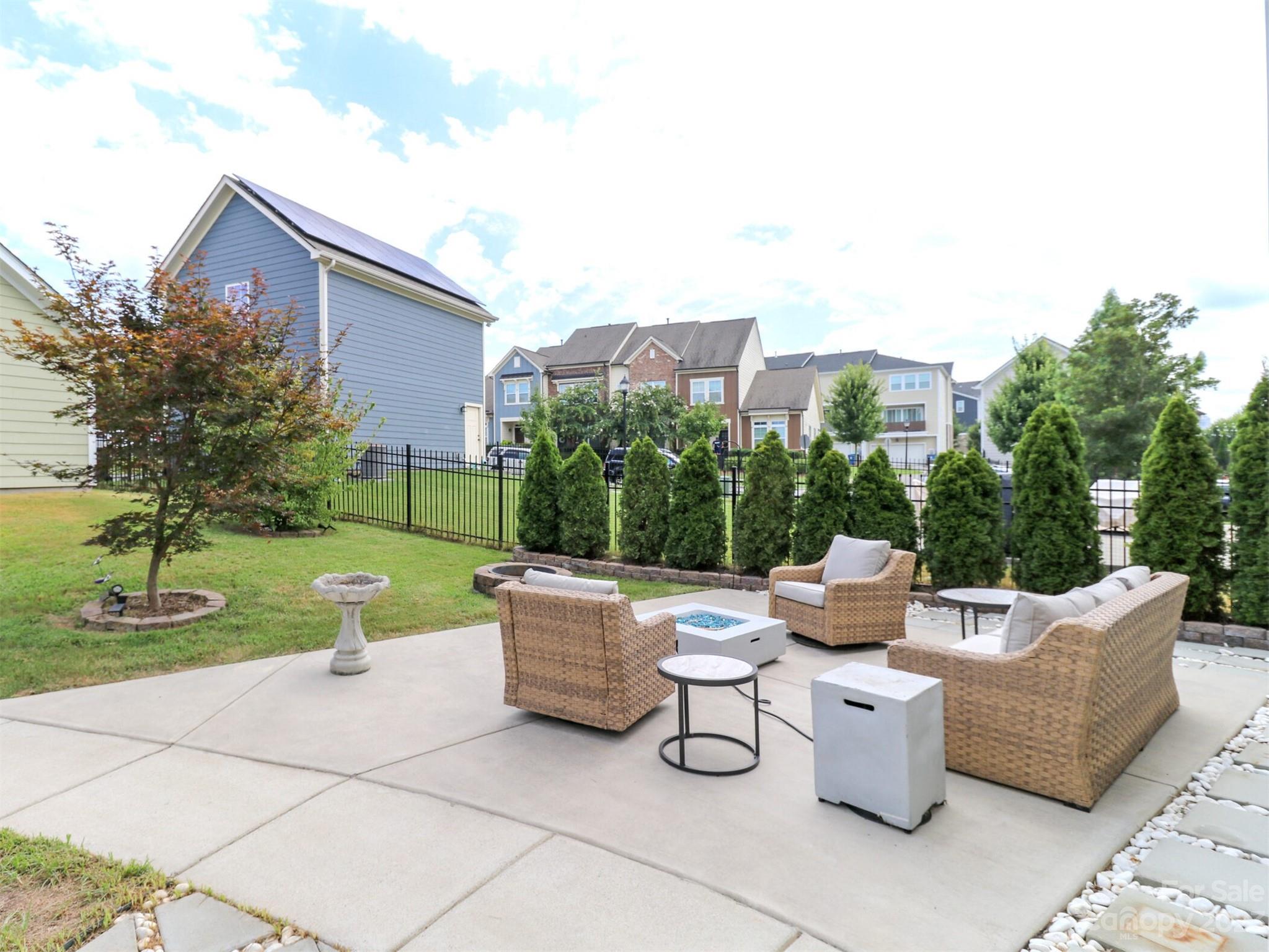2634 Double Oaks Road Charlotte, NC 28206 - Photo 37 of 48 a view of a patio with couches chairs and a fire pit
