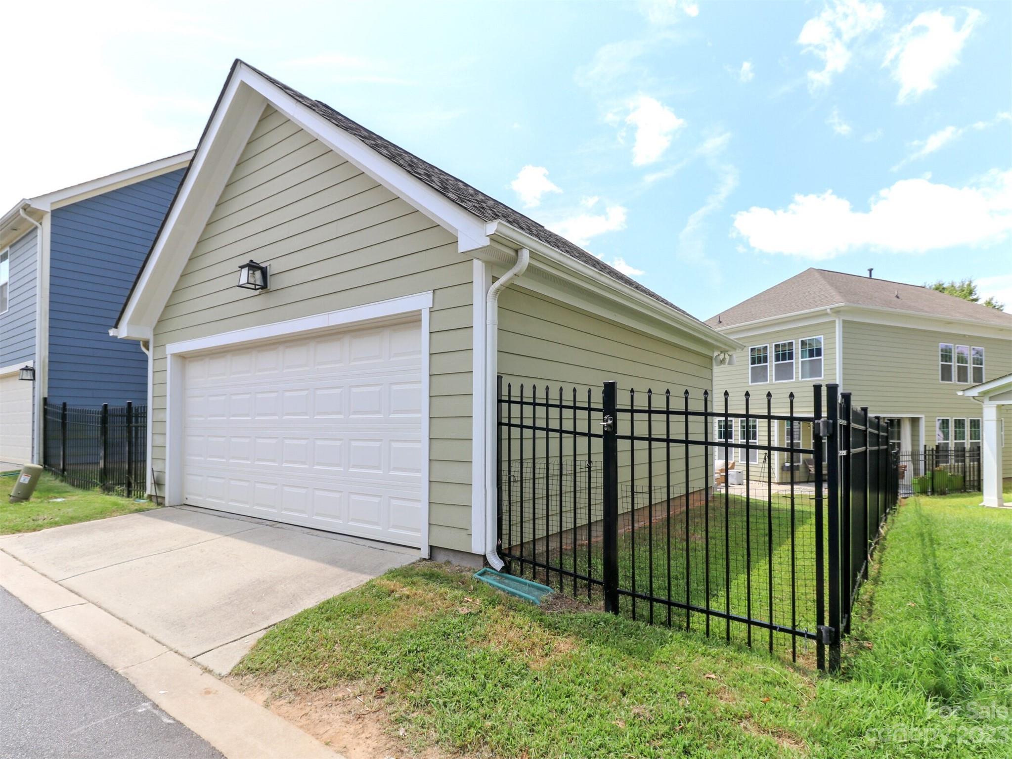 2634 Double Oaks Road Charlotte, NC 28206 - Photo 40 of 48 a view of a white house with a small yard and plants