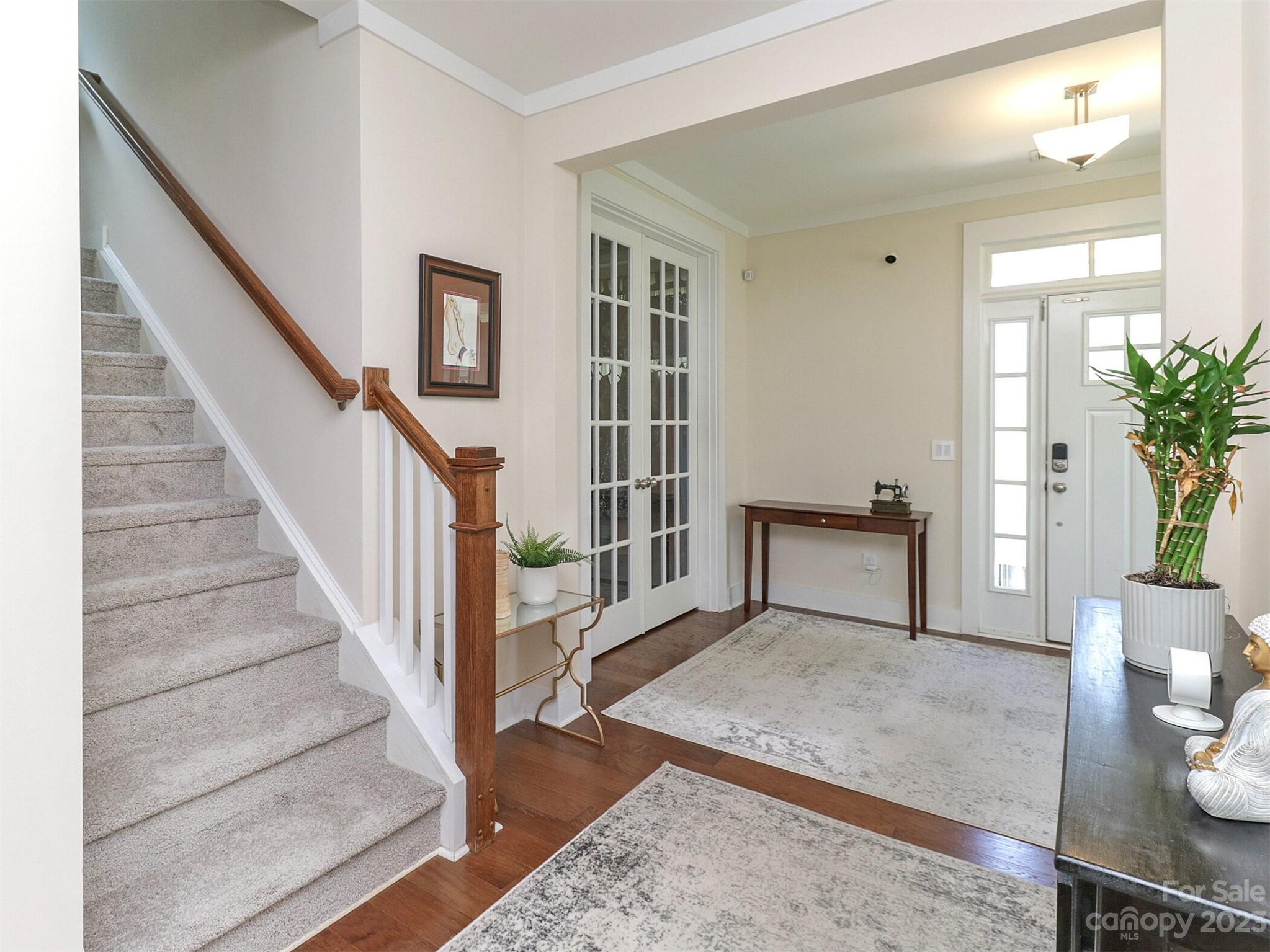 2634 Double Oaks Road Charlotte, NC 28206 - Photo 7 of 48 a view of an empty room with wooden floor and a potted plant