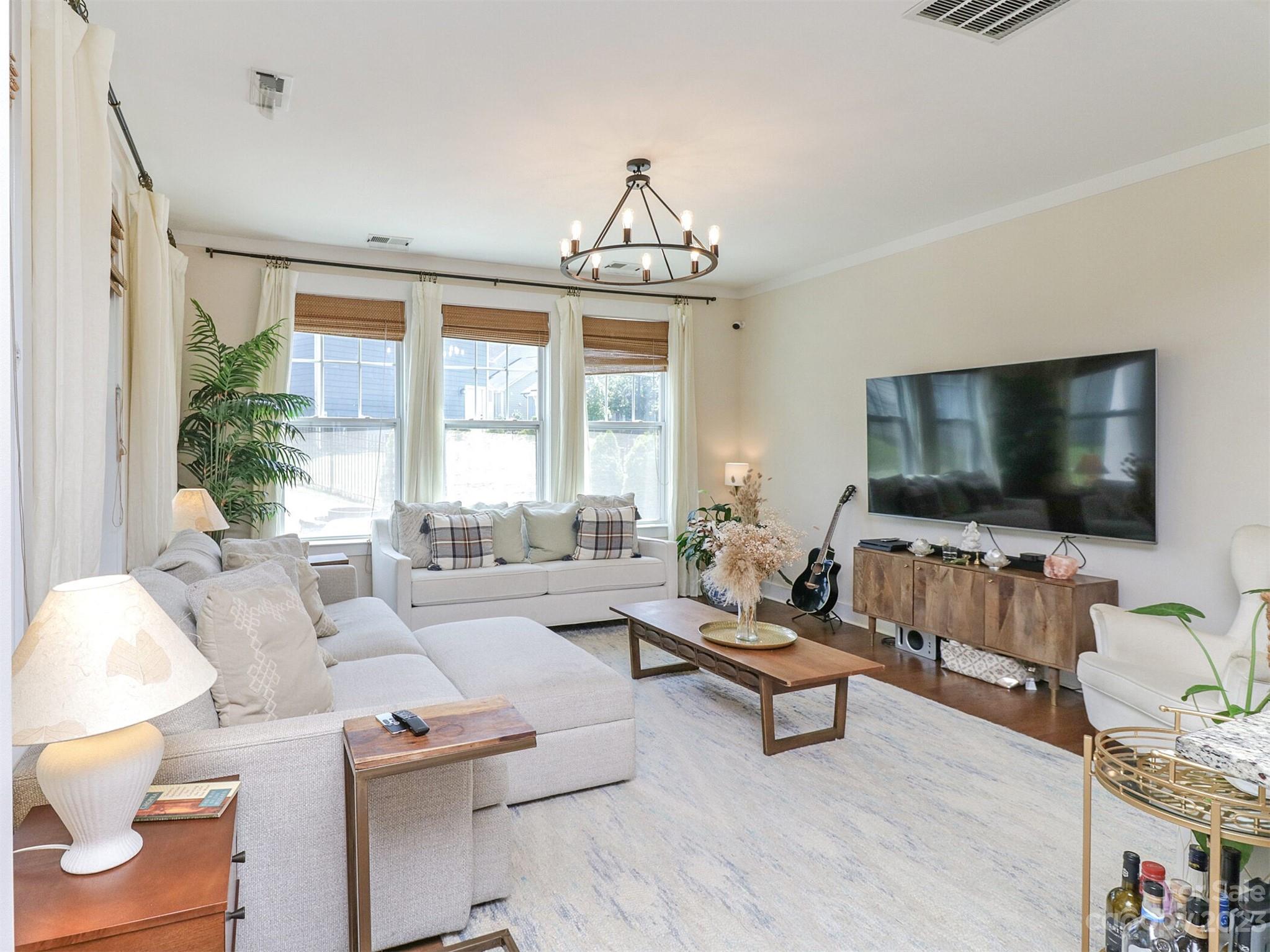 2634 Double Oaks Road Charlotte, NC 28206 - Photo 9 of 48 a living room with furniture and a flat screen tv