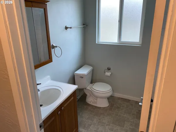 a white toilet sitting next to a bathroom sink