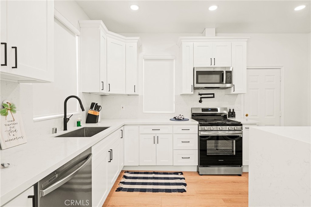 1014 Myrtle Avenue Long Beach, CA 90813 - Photo 12 of 70 a kitchen with stainless steel appliances granite countertop a stove a sink and a microwave