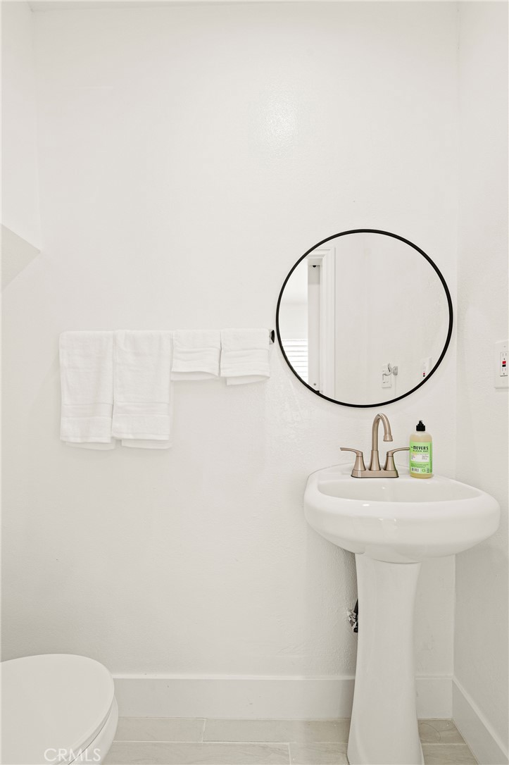 1014 Myrtle Avenue Long Beach, CA 90813 - Photo 31 of 70 a bathroom with a sink a mirror and a toilet