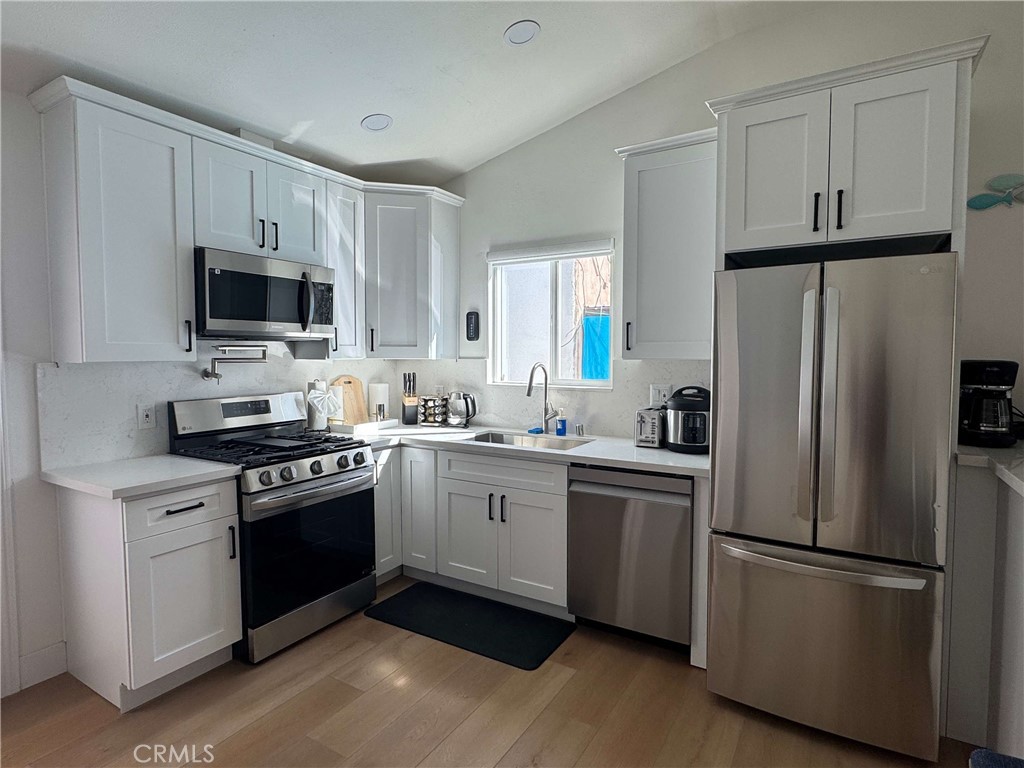 1014 Myrtle Avenue Long Beach, CA 90813 - Photo 42 of 70 a kitchen with stainless steel appliances a refrigerator sink and microwave