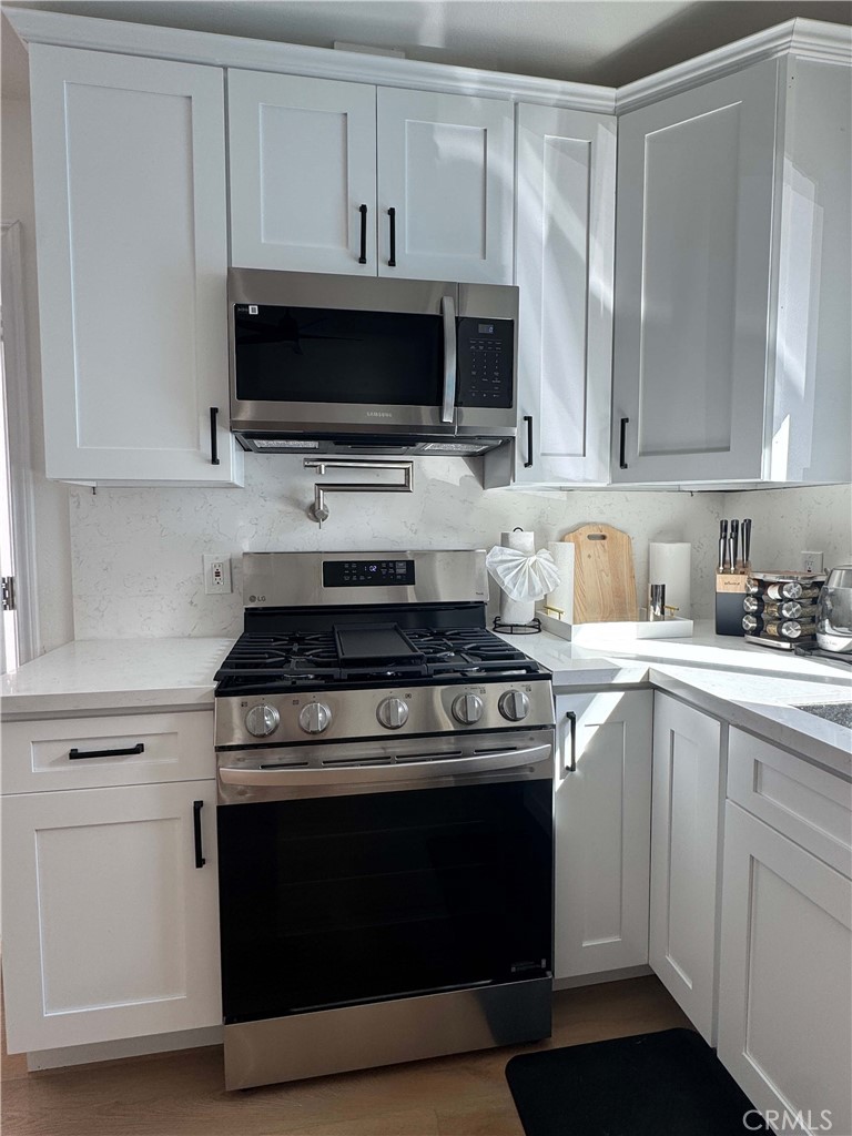 1014 Myrtle Avenue Long Beach, CA 90813 - Photo 43 of 70 a kitchen with stainless steel appliances a stove a microwave and cabinets