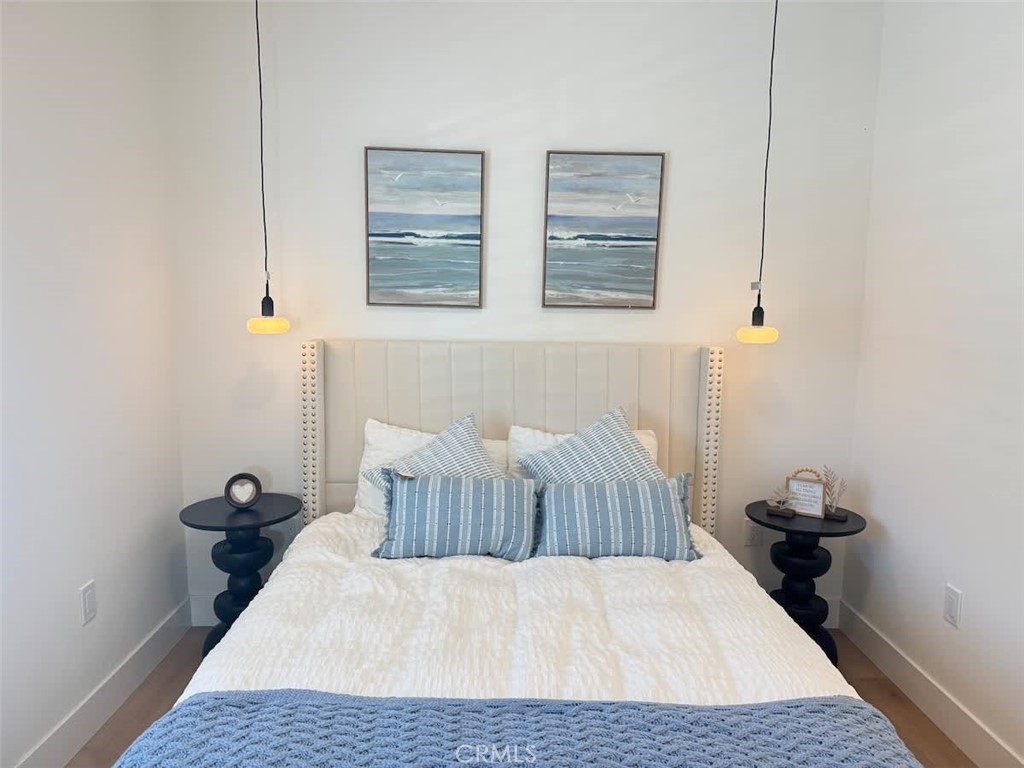 1014 Myrtle Avenue Long Beach, CA 90813 - Photo 47 of 70 a bedroom with a bed and wooden floor