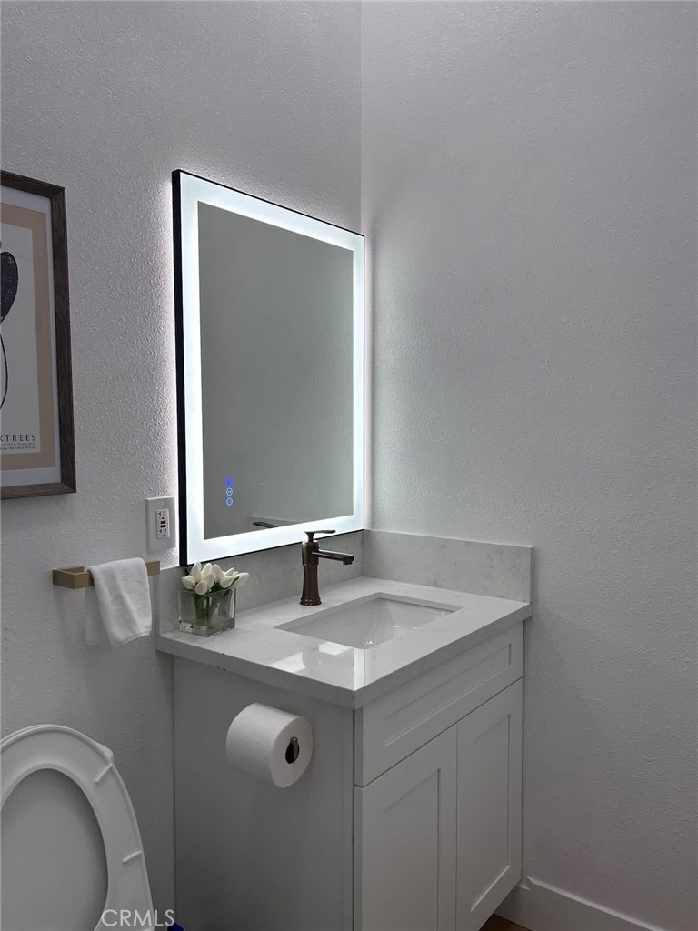 1014 Myrtle Avenue Long Beach, CA 90813 - Photo 54 of 70 a bathroom with a granite countertop sink and a mirror